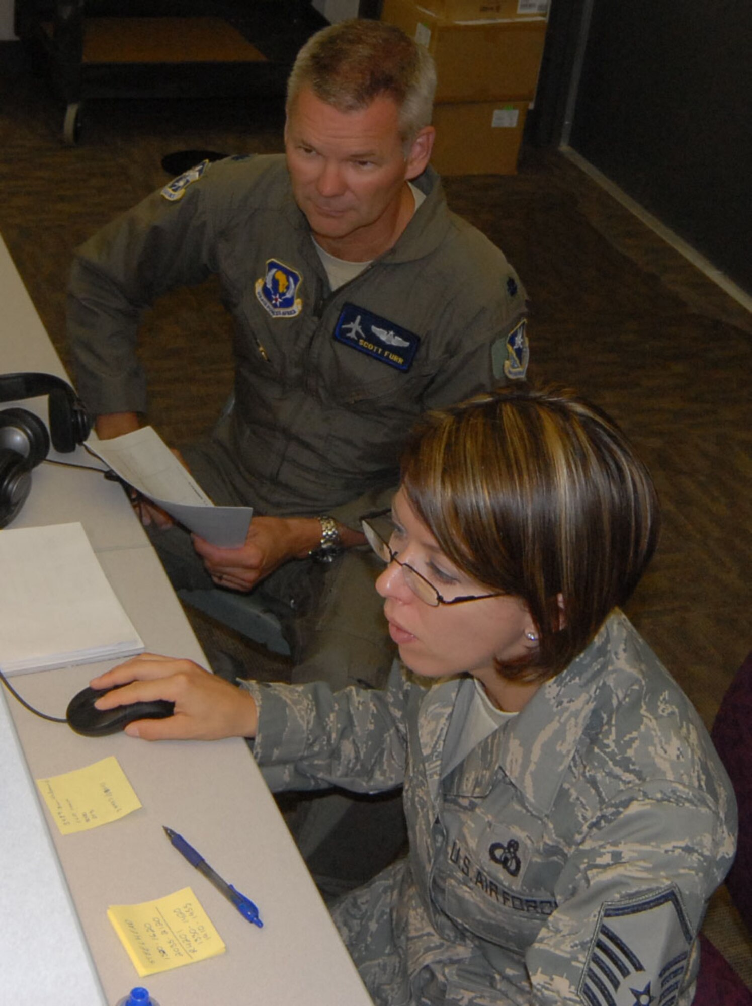 Master Sgt. Tara Martinelli of 17th Air Force and Lt. Col. Scott Furr of the 110th Air Operations Group monitor combat airspace during the exercise Objective Focus 2010 at Battle Creek Air National Guard Base held Aug. 9-13.  (U.S. Air Force photo by Tech. Sgt. Alec Lloyd)