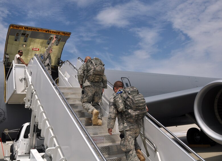 Staff Sgt. Scott Frazer, a 128th Air Refueling Wing security forces team member, waves good-bye to his wife and three children as he boards a KC-135R Stratotanker on Tuesday, August 10, 2010.  Frazer, along with 12 other security forces Airmen, deployed to Southwest Asia to provide base security in support of Operation Enduring Freedom.  (U.S. Air Force photo by Senior Airman Ryan Kuntze / released)