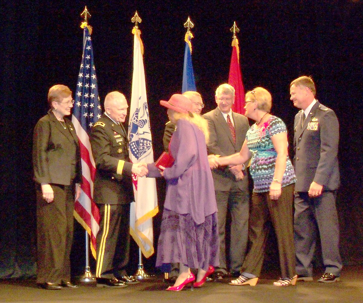 Ms. Paula Sumrall, Director of Volunteer Programs, Major General Raymond Carpenter, acting Director of the Army National Guard, Major General Lawrence Ross, Director of Manpower and Personnel at J1, Mr. Alex Baird, Chief of Family Programs present the Red Hat Militia members Chris Monger and Linnae Soldatke with the Purple Award at a presentation in New Orleans, LA Aug. 2.  Also pictured and in attendance was Colonel Russ Walz,114th Fighter Wing commander of the SouthDakota Air National Guard.