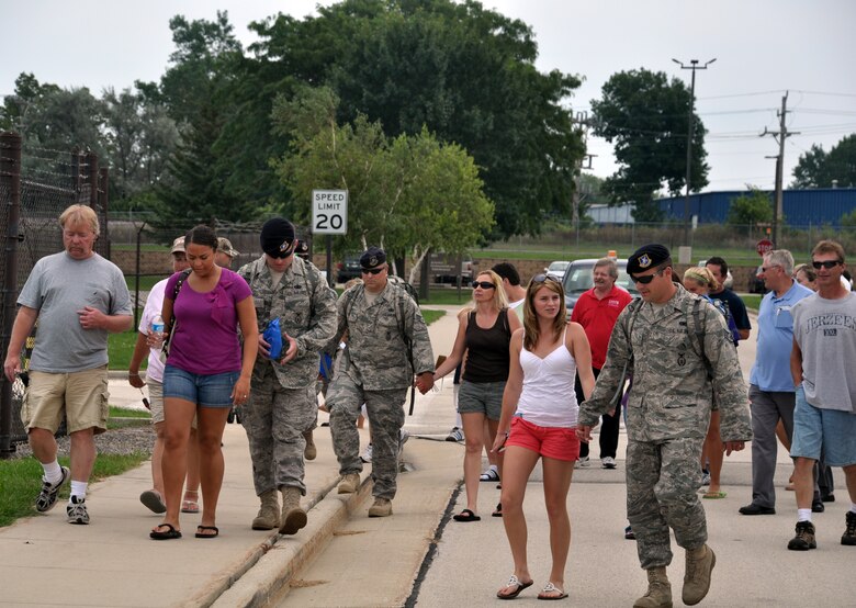 128th Air Refueling Wing security forces Airmen walk with their families to the flightline gate on Tuesday, August 10, 2010, at Gen. Mitchell International Airport, Milwaukee.  The security forces team members deployed to Southwest Asia in support of Operation Enduring Freedom.  (U.S. Air Force photo by Senior Airman Ryan Kuntze / released)