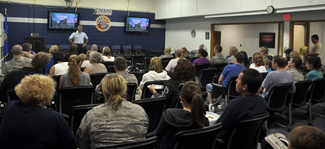 Col. John Putre, the vice commander of the 128th Air Refueling Wing, expresses his support for deploying security forces team members on Tuesday, August 10, 2010.  The security forces Airmen were joined by their family members prior to boarding a KC-135R Stratotanker to begin their deployment overseas.  (U.S. Air Force photo by Senior Airman Ryan Kuntze / released)