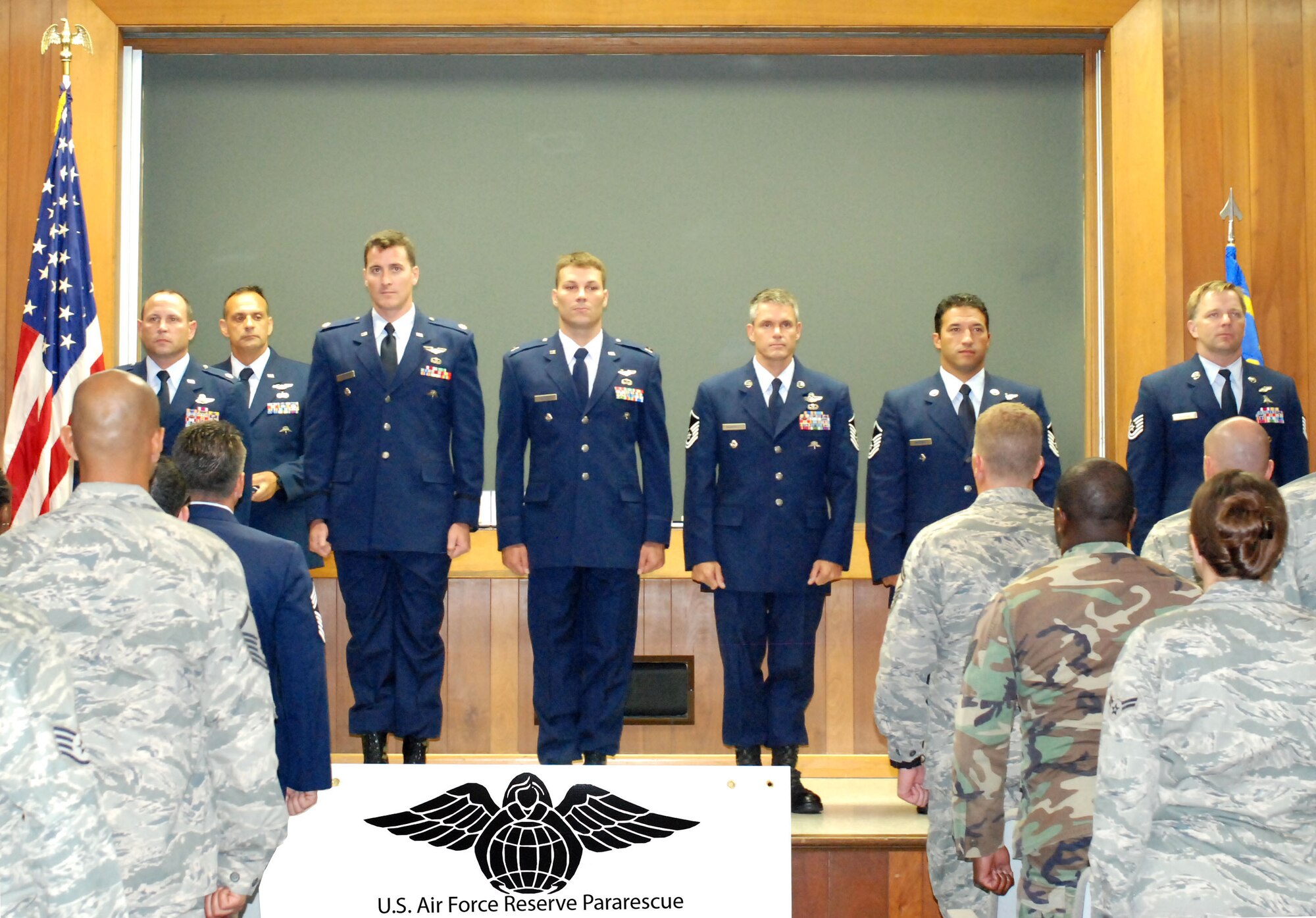 PATRICK AIR FORCE BASE, Fla. -- Members of the 920th Rescue Wing stand at attention during an awards ceremony Aug. 8 at the 308th Rescue Squadron Commander's Call here. They received medals for actions that included wading in waist-deep snow in negative 20 degrees Fahrenheit in an avalanche in Afghanistan, restoring order, saving lives and evacuating flood victims in the wake of Hurricane Ike, support of the NASA Space Shuttle contingency response plan, the medical evacuation of Coalition forces in support of Operations Enduring Freedom and Iraqi Freedom and the conversion and activation of the Guardian Angel Weapon System at the 308th Rescue Squadron; part of the 920th RQW. Its Airmen engage in three of the Air Force Reserve's most cutting-edge and satisfying missions: combat search and rescue; space support; and humanitarian assistance. (U.S. Air Force photo/Staff Sgt. Ken Salgat)