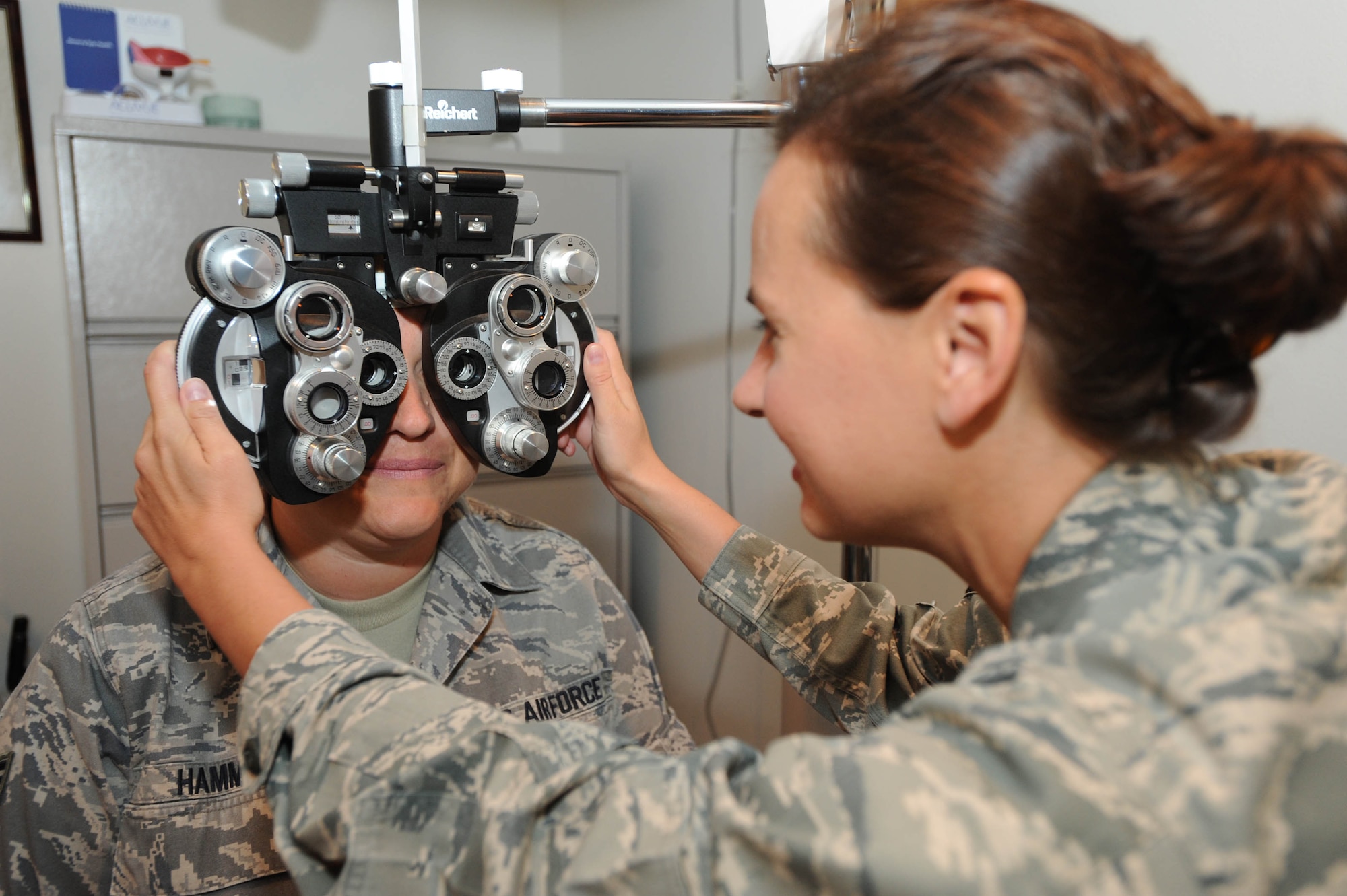 WHITEMAN AIR FORCE BASE, Mo. - Maj. Mia Jennings, 509th Medical Operations Squadron, optometrist, uses a phoropter  to check the prescription of the patient's eyes, Aug. 11. (U.S. Air Force photo by Senior Airman Carlin Leslie) 

