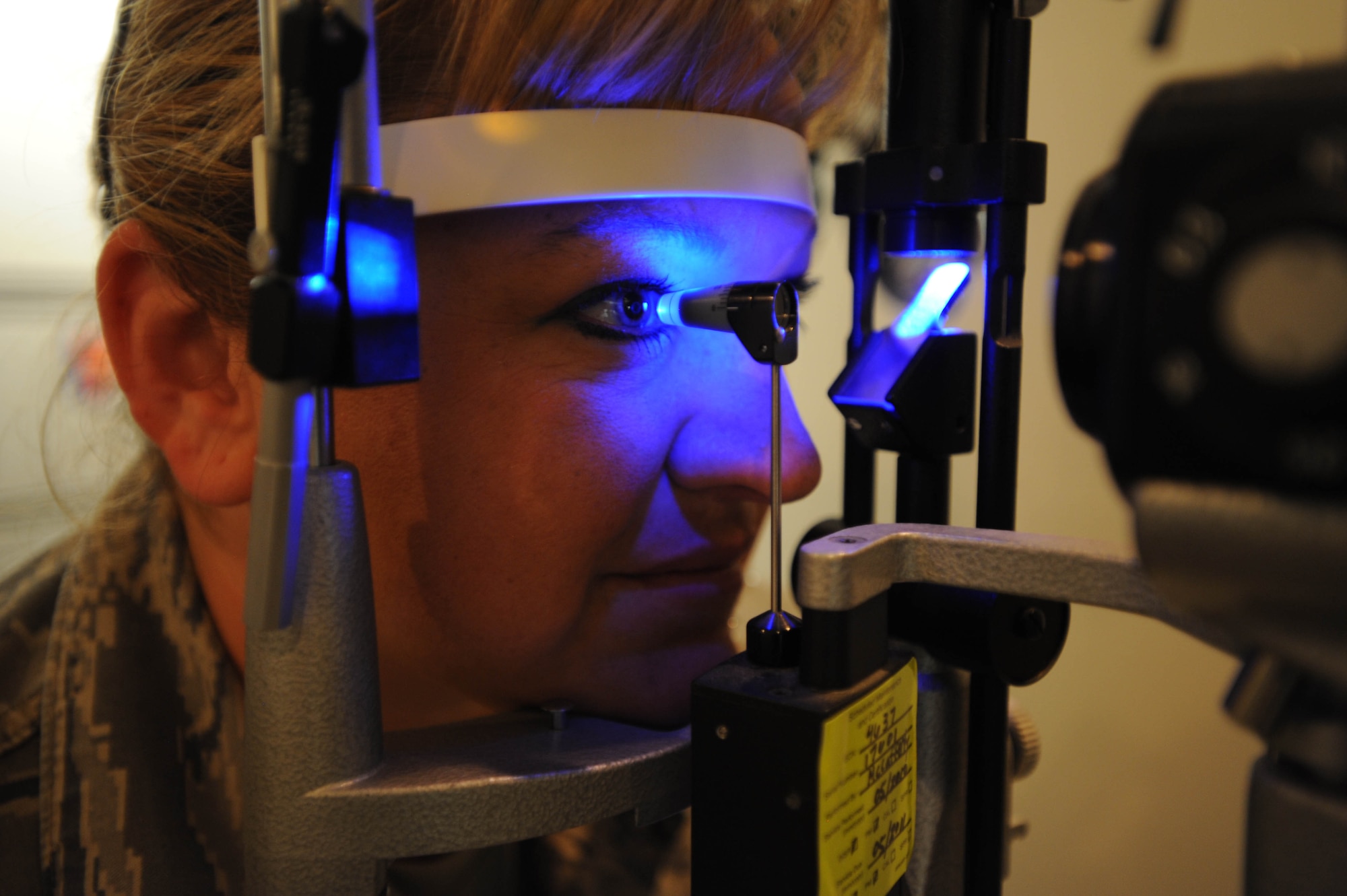 WHITEMAN AIR FORCE BASE, Mo. -  Tech. Sgt. Monica Hamm, 509th Medical Operations Squadron optometry clinic, has the pressure of her eye checked on an applanation tonometer, Aug 11. (U.S. Air Force photo by Senior Airman Carlin Leslie)

