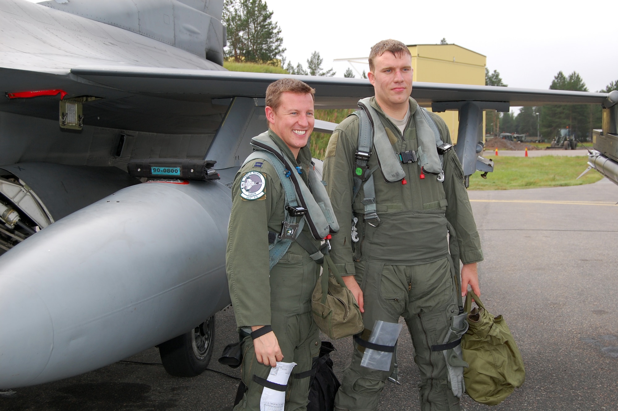 Capt. Ryan Thulin (left), 555th Fighter Squadron pilot, poses with Staff Sgt. Jared Moffitt, 31st Aircraft Maintenance Squadron weapons load crew member, after flying together on a familiarization flight in an F-16 Aug. 6, 2010 at Kallax Air Base, Sweden. The 555th FS spent two weeks working with the Swedish air force at Norrbotten Wing conducting air-to-air and air-to-ground training missions. (U.S. Air Force photo by Tech. Sgt. Lindsey Maurice/Released)