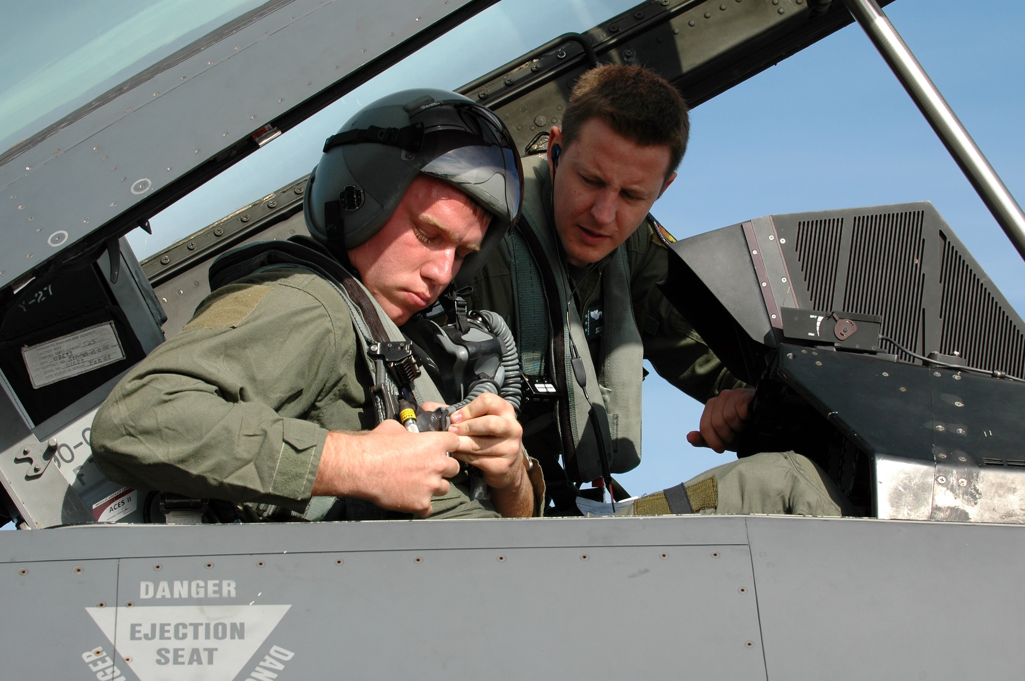 Capt. Ryan Thulin (right), 555th Fighter Squadron pilot, covers a few safety precautions with Staff Sgt. Jared Moffitt, 31st Aircraft Maintenance Squadron weapons load crew member, before flying together on a familiarization flight in an F-16 Aug. 6, 2010 at Kallax Air Base, Sweden. The 555th FS spent two weeks working with the Swedish air force at Norrbotten Wing conducting air-to-air and air-to-ground training missions. (U.S. Air Force photo by Tech. Sgt. Lindsey Maurice/Released)