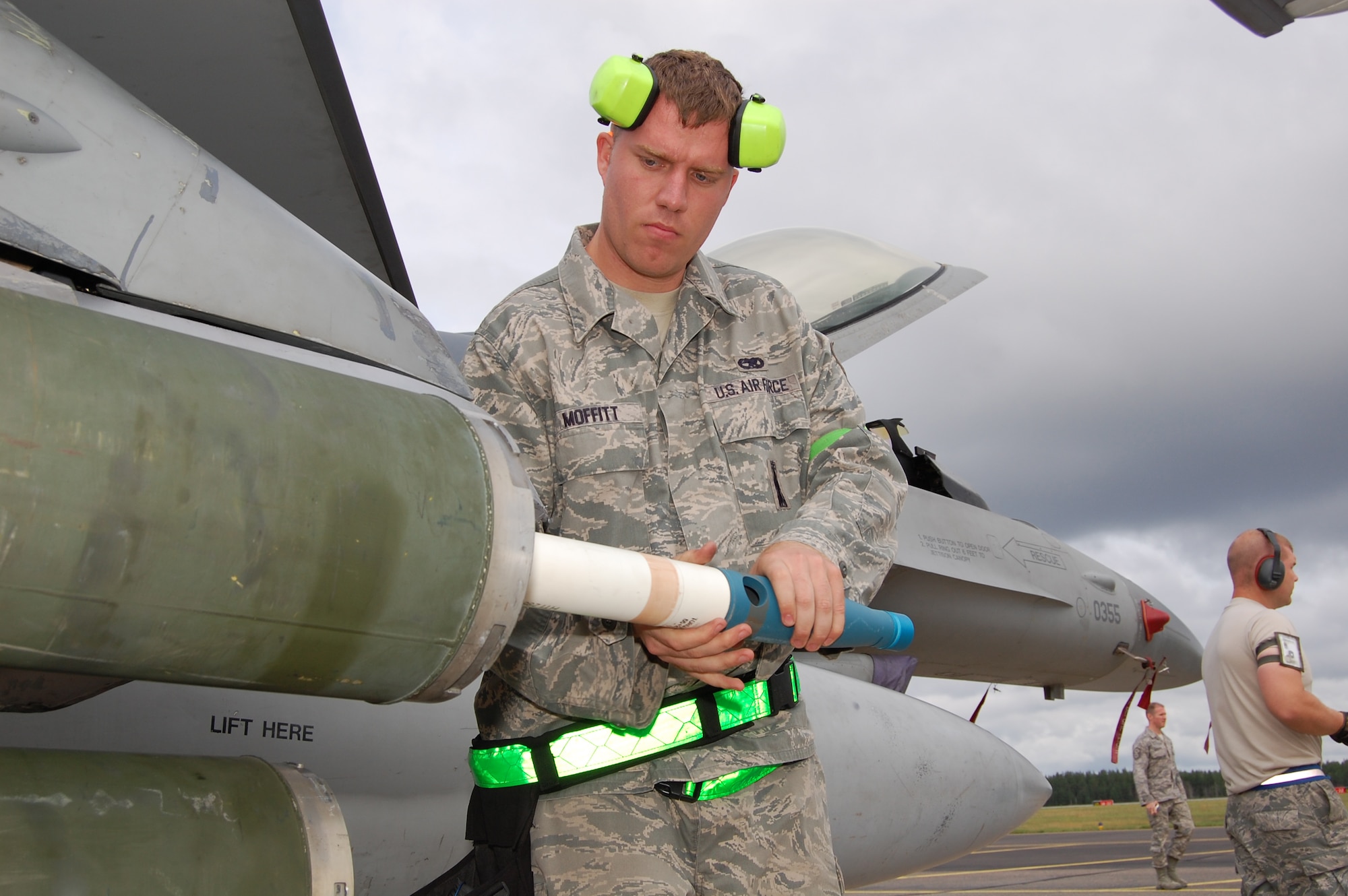 Staff Sgt. Jared Moffitt, 31st Aircraft Maintenance Squadron weapons load crew member, loads practice munitions onto an F-16 Aug. 5, 2010 during a training exercise at Kallax Air Base, Sweden. The 555th FS spent two weeks working with the Swedish air force at Norrbotten Wing conducting air-to-air and air-to-ground training missions. (U.S. Air Force photo by Tech. Sgt. Lindsey Maurice/Released)