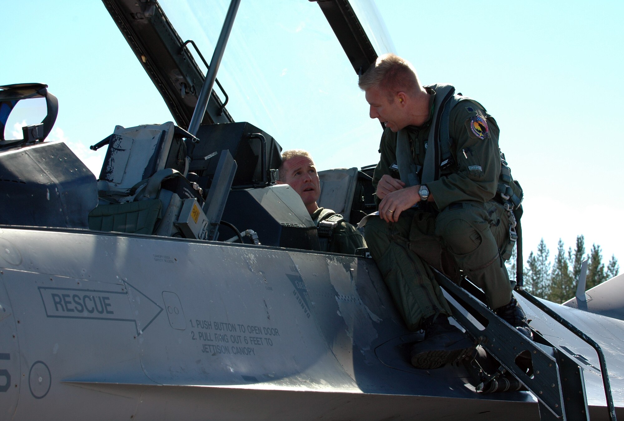 Lt. Col. Karl Ingeman, 555th Fighter Squadron commander, goes over some in-flight safety rules with Master Sgt. Christopher Sawaryn, 31st Aircraft Maintenance Squadron first sergeant, before a familiarization flight Aug. 5, 2010 at Kallax Air Base, Sweden.The 555th FS spent two weeks working with the Swedish air force at Norrbotten Wing conducting air-to-air and air-to-ground training missions. (U.S. Air Force photo by Tech. Sgt. Lindsey Maurice/Released)