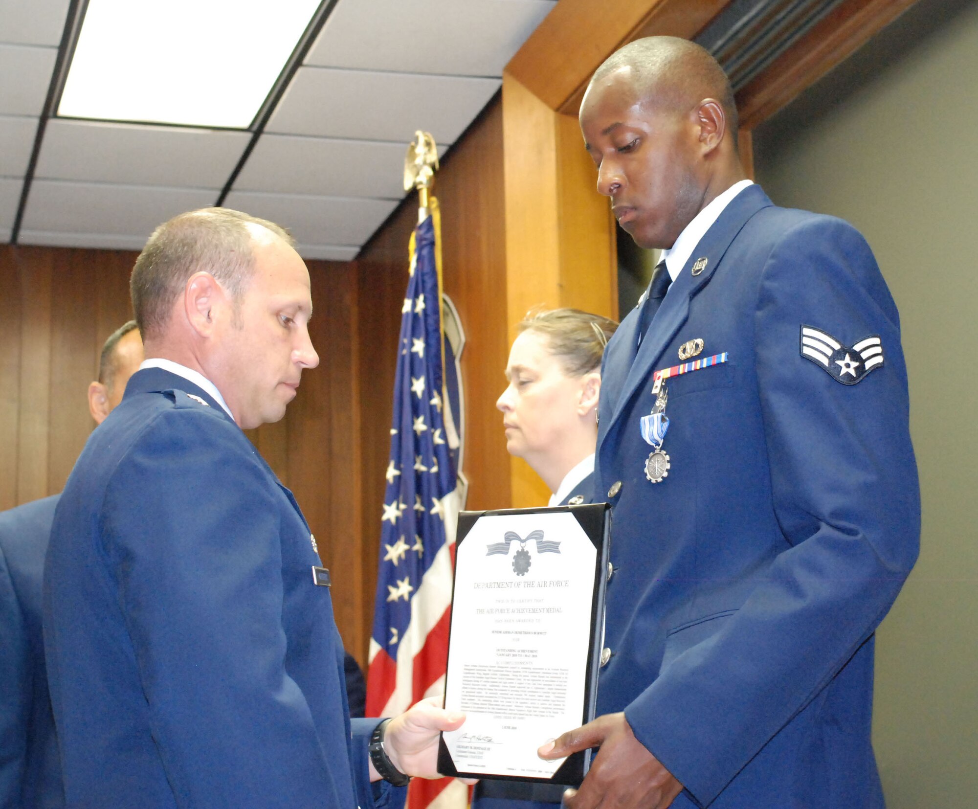 PATRICK AIR FORCE BASE, Fla. -- Lt. Col. Kurt Matthews (L) presents the Air Force Achievement Medal to Senior Airman Demetrious Burnett for outstanding achievement in the surveillance of real time intelligence during 67 combat missions and eight sorties in Afghanistan. An Air Force Reserve aviation resource management journeyman with the 920th Rescue Wing, Airman Burnett received his awards for his exceptional service helping to rescue and evacuate survivors of 36 avalanches in Salang Pass in Afghanistan. The 920th Rescue Wing Airmen engages in three of the Air Force Reserve's most cutting-edge and satisfying missions: combat search and rescue; space support; and humanitarian assistance. (U.S. Air Force photo/Staff Sgt. Ken Salgat)