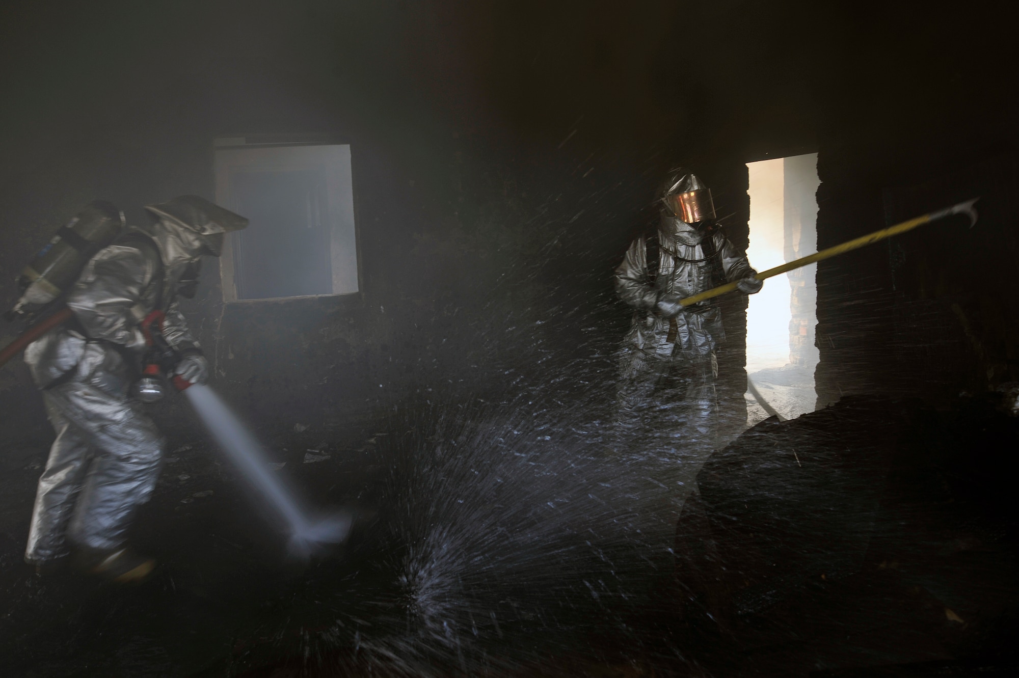 Baghdad International Airport firefighters search for any hidden fires during live burn training, Aug. 9, 2010, at BIAP, Iraq. Firefighters from the 447th ECES, BIAP and Iraqi air force, frequently train in structural firefighting, to improve their skills. ( U.S. Air Force photo by Senior Airman Perry Aston) (Released)