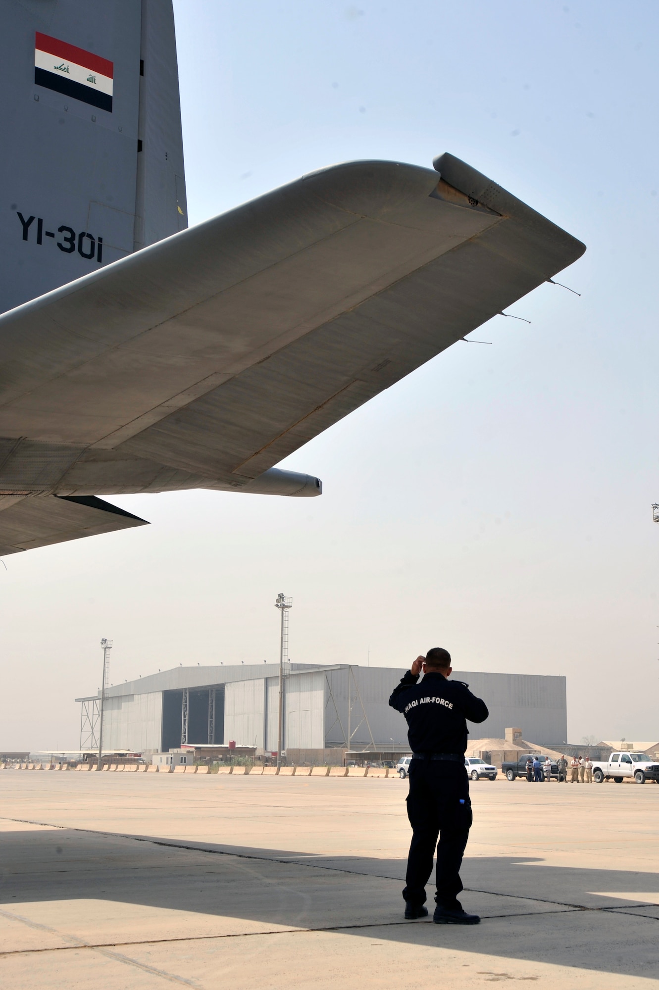 An Iraqi air force fire chief makes radio contact with his fire crew Aug. 5, 2010 at New Al Muthana Air Base, Iraq. The firefighters demonstrated to Iraq training and advisory leaders, and Iraqi air force leadership, their ability to protect Iraqi air force assets and save lives. ( U.S. Air Force photo by Senior Airman Perry Aston) (Released)