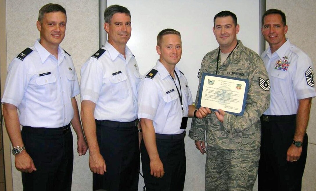 LANGLEY AIR FORCE BASE, Va. -- Tech. Sgt. Michael Day, 1st Operations Group (in ABU), receives his STEP promotion certificate from Maj. Brock Molden, 1 OG, alongside, Col. Kevin Mastin, 1st Fighter Wing vice commander, Lt. Col. Michael King, 1 OG, and Chief Master Sgt. Kevin Jurgella, 1 FW command chief, Aug. 9. Sergeant Day recieved the promotion from Air Combat Command commander Gen. William Fraser after returning home from a year-long deployment. (Photo courtesy/Chief Master Sgt. Kevin Jurgella)
