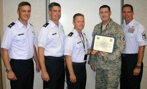 LANGLEY AIR FORCE BASE, Va. -- Tech. Sgt. Michael Day, 1st Operations Group (in ABU), receives his STEP promotion certificate from Maj. Brock Molden, 1 OG, alongside, Col. Kevin Mastin, 1st Fighter Wing vice commander, Lt. Col. Michael King, 1 OG, and Chief Master Sgt. Kevin Jurgella, 1 FW command chief, Aug. 9. Sergeant Day recieved the promotion from Air Combat Command commander Gen. William Fraser after returning home from a year-long deployment. (Photo courtesy/Chief Master Sgt. Kevin Jurgella)