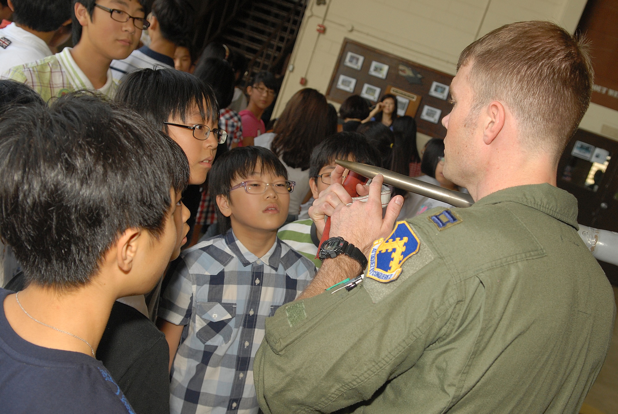KUNSAN AIR BASE, Republic of Korea -- Capt. Bryan McGuire, 80th Fighter Squadron pilot, explains the importance of the many different components of an F-16 fighter jet to English camp tour students here Aug. 11. More than 60 students from several elementary and middle schools in Gunsan city participated  in the tour. (U.S. Air Force photo/Senior Airman Ciara Wymbs)