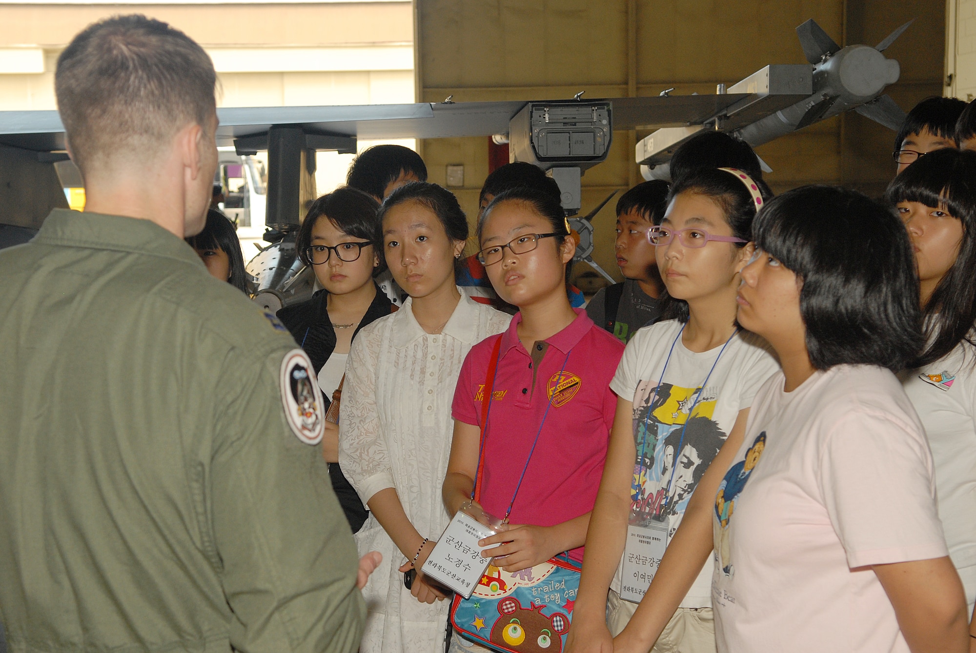 KUNSAN AIR BASE, Republic of Korea -- Capt. Bryan McGuire, 80th Fighter Squadron pilot, explains to English camp tour students Aug. 11 what it feels like to be a pilot and to fly. More than 60 students from several elementary and middle schools participated in the tour. (U.S. Air Force photo/Senior Airman Ciara Wymbs) 