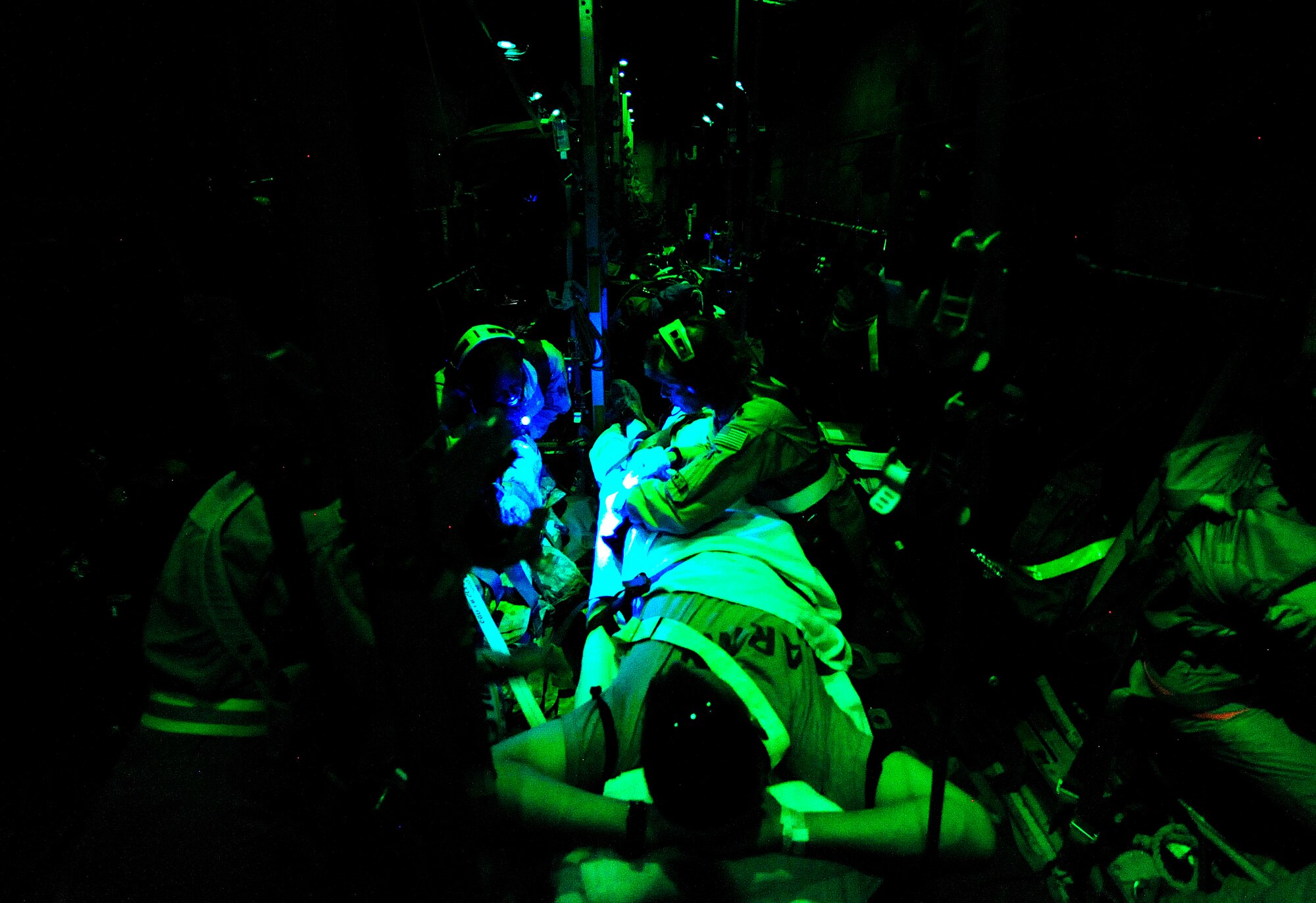 U.S. Air Force reservist Maj. Marty Maddox a flight nurse assigned to the 362nd Expeditionary Aeromedical Evacuation Flight, observes patients bandages during an aeromedical mission aboard a C-130 Hercules aircraft from Tikrit to Joint Base Balad, Iraq on July 17, 2010.  
(U.S. Air Force photo by Staff Sgt. Andy M. Kin / Released)