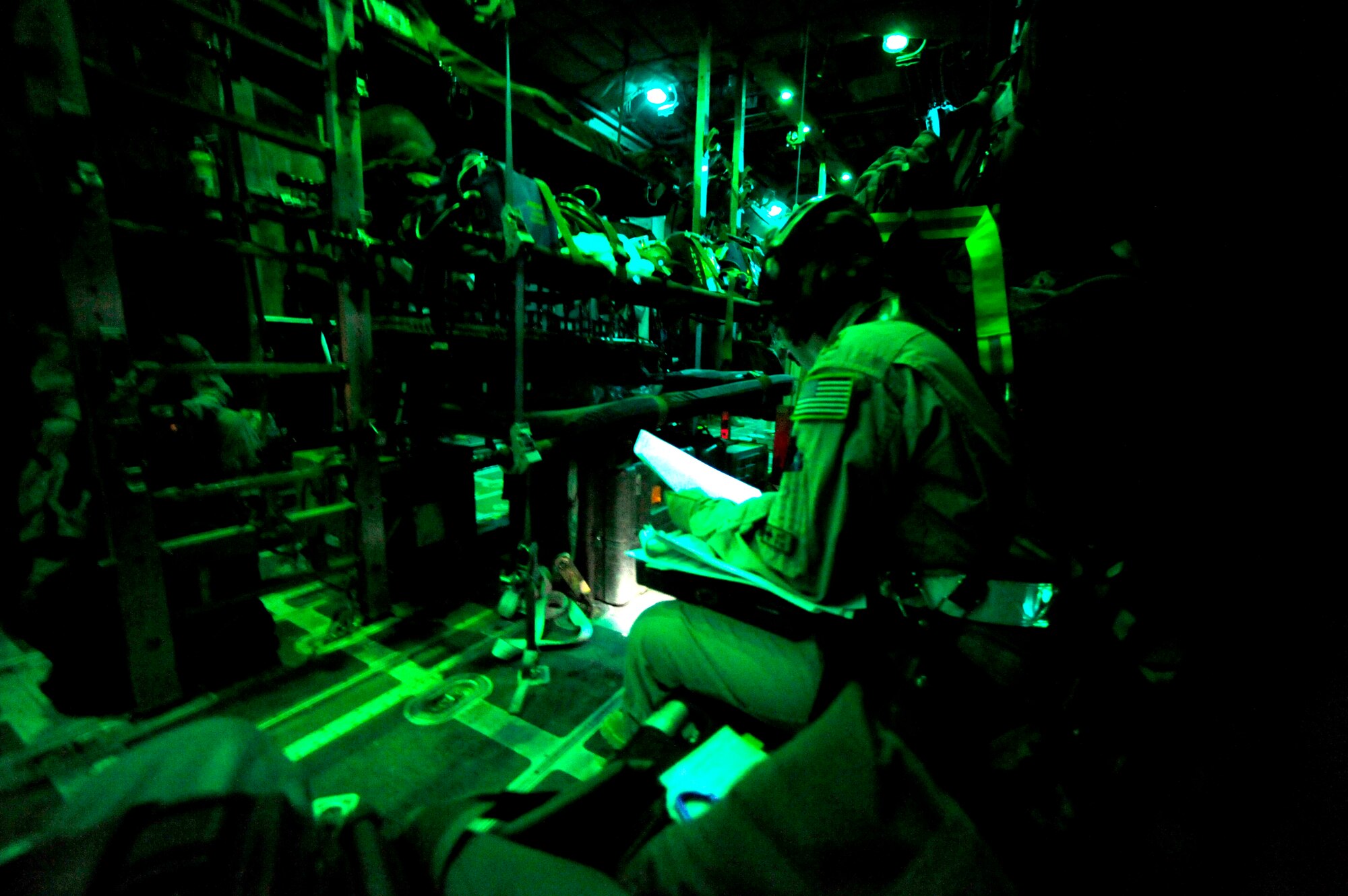 U.S. Air force reservist Maj. Marty Maddox a flight nurse assigned to the 362nd Expeditionary Aeromedical Evacuation Flight, scans over patient list during aeromedical flight aboard a C-130 Hercules aircraft at Joint Base Balad, Iraq on July 17, 2010.
(U.S. Air Force photo by Staff Sgt. Andy M. Kin / Released)