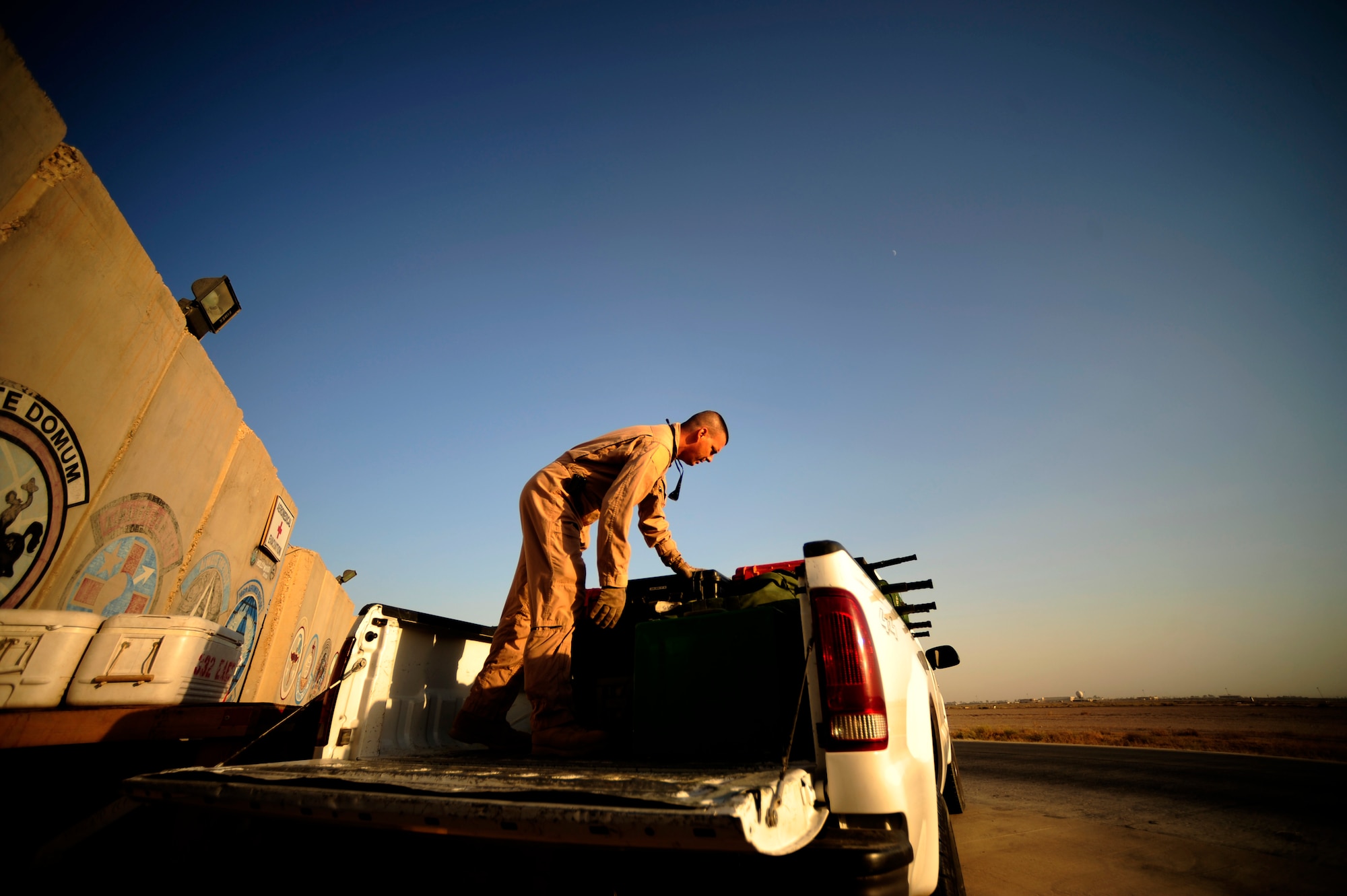 U.S. Air Force reservist Senior Master Sgt. Tony Staut a aeromedical evacuation technician assigned to the 362nd Expeditionary Aeromedical Evacuation Flight, loads gear in pick up for transit to the plane prior to flying mission at Joint Base Balad, Iraq on July 17, 2010.
(U.S. Air Force photo by Staff Sgt. Andy M. Kin / Released)