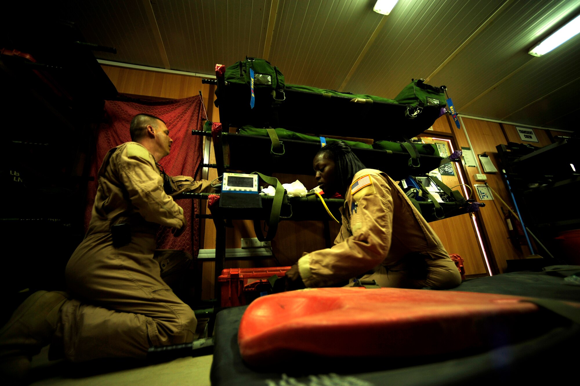 U.S. Air Force aeromedical evacuation technicians reservists Senior Master Sgt. Tony Staut,(right) and Senior Airman Nicole Caldwell assigned to the 362nd Expeditionary Aeromedical Evacuation Flight, scan in all required gear and medical supplies for flying mission out of Joint Base Balad, Iraq on July 17, 2010.
(U.S. Air Force photo by Staff Sgt. Andy M. Kin / Released)