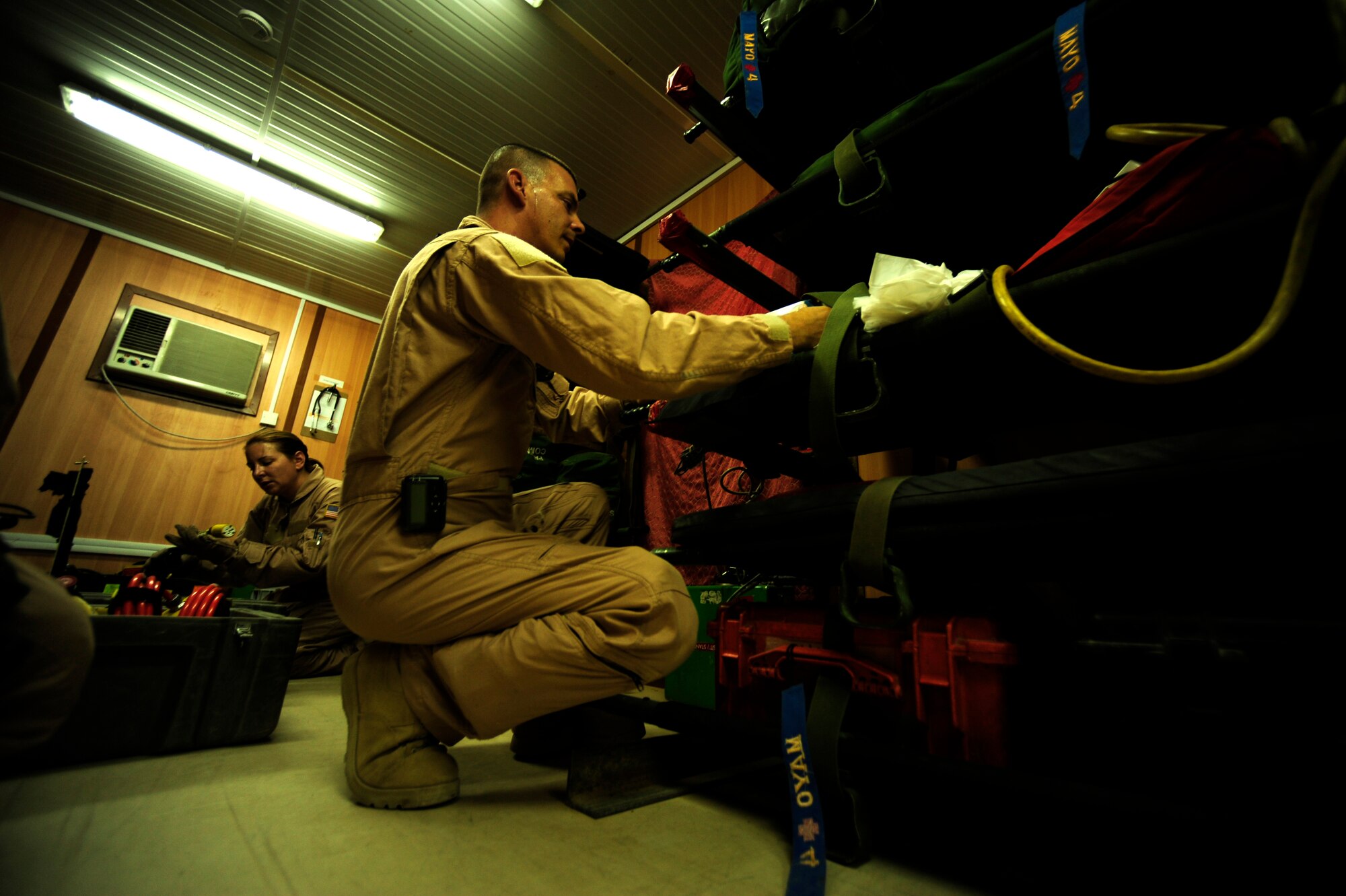 U.S. Air Force reservists Senior Master Sgt. Tony Stuat and Tech Sgt. Margerite Hellwich, aeromedical evacuation technicians assigned to the 362nd Expeditionary Aeromedical Evacuation Flight, prep medical gear prior to mission brief at Joint Base Balad, Iraq on July 17, 2010. 
(U.S. Air Force photo by Staff Sgt. Andy M. Kin / Released)