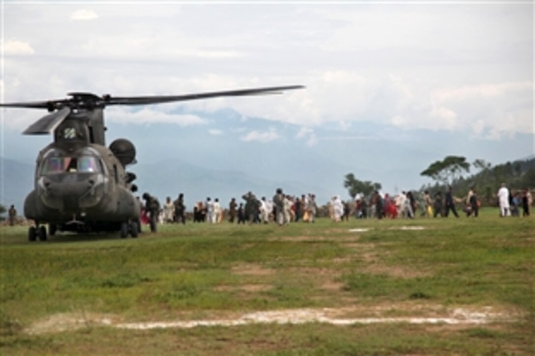 A U.S. Army CH-47 Chinook helicopter unloads evacuees from the town of Kalam, Pakistan, as part of the flood recovery effort in that nation's Khyber Pakhtunkhwa Province, Aug. 10, 2010. The helicopter crew is assigned to the 3rd Infantry Division's 2nd Battalion, 3rd Combat Aviation Brigade.