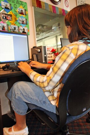 Marina Goodsell, a member of the Youth and Teen Center, sits at one of the computers to write an essay at the Youth and Teen Center here Aug. 12. For membership registration forms and parental permission forms visit mccsiwakuni.com.