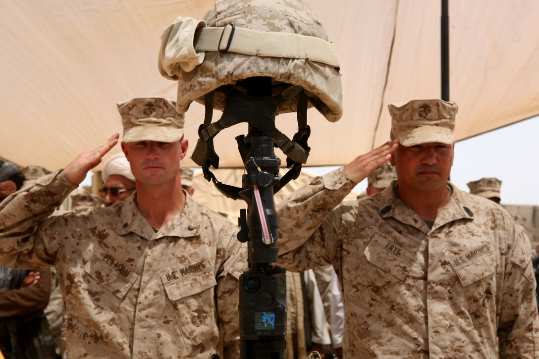 Lt. Col. Kyle B. Ellison, left, commanding officer of 2nd Battalion, 6th Marine Regiment, and Sgt. Maj. William Frye, sergeant major of 2/6, salute the memorial stand of Lance Cpl. Abram L. Howard during a memorial service at the Marjah District government center in Marjah, Afghanistan, Aug. 12, 2010. Howard, from Williamsport, Pa., was killed July 27 while conducting combat operations in Helmand province, Afghanistan.