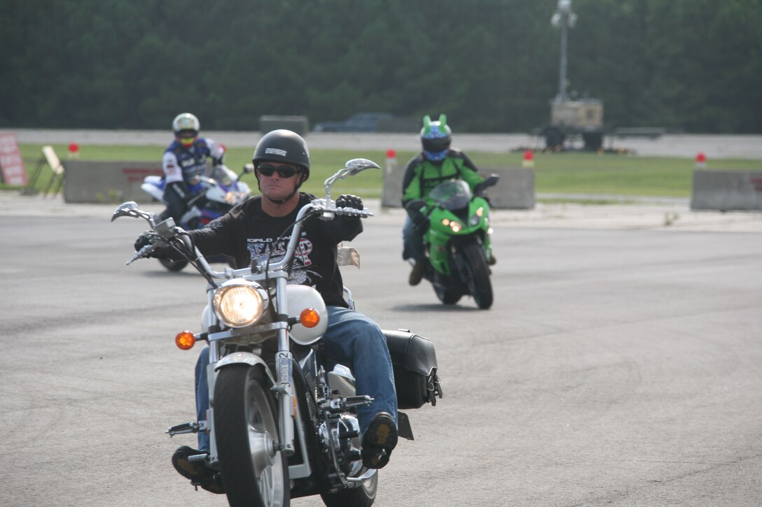 Chief Warrant Officer 2 Larry Earl, the motorcycle club president for Marine Wing Support Squadron 271, leads a pack of motorcyclists around the motorcycle safety course aboard Marine Corps Auxiliary Landing Field Bogue after a MWSS-271 motorcycle ride Aug. 12. The riders left MCALF Bogue around 8 a.m. and returned around 4 p.m.