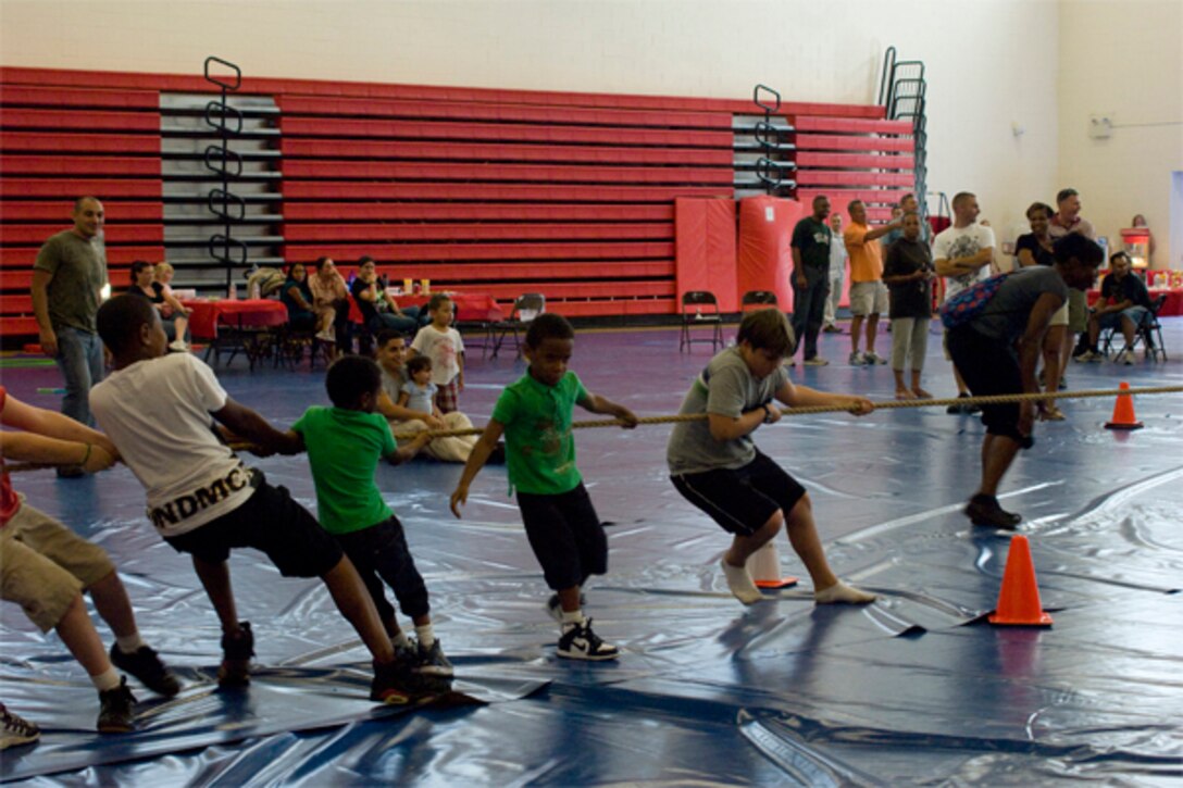 Malachi Velario, son of Sgt. Rene Valerio the logistics non-commissioned officer for the Marine Corps Recruiting Command,  makes tug-of-war look easy as he helps his team with one hand. Tug-of-war was just one of the events that took place at the 2010 MCRC Family Day at Barber Physical Activity Center Aug.12.