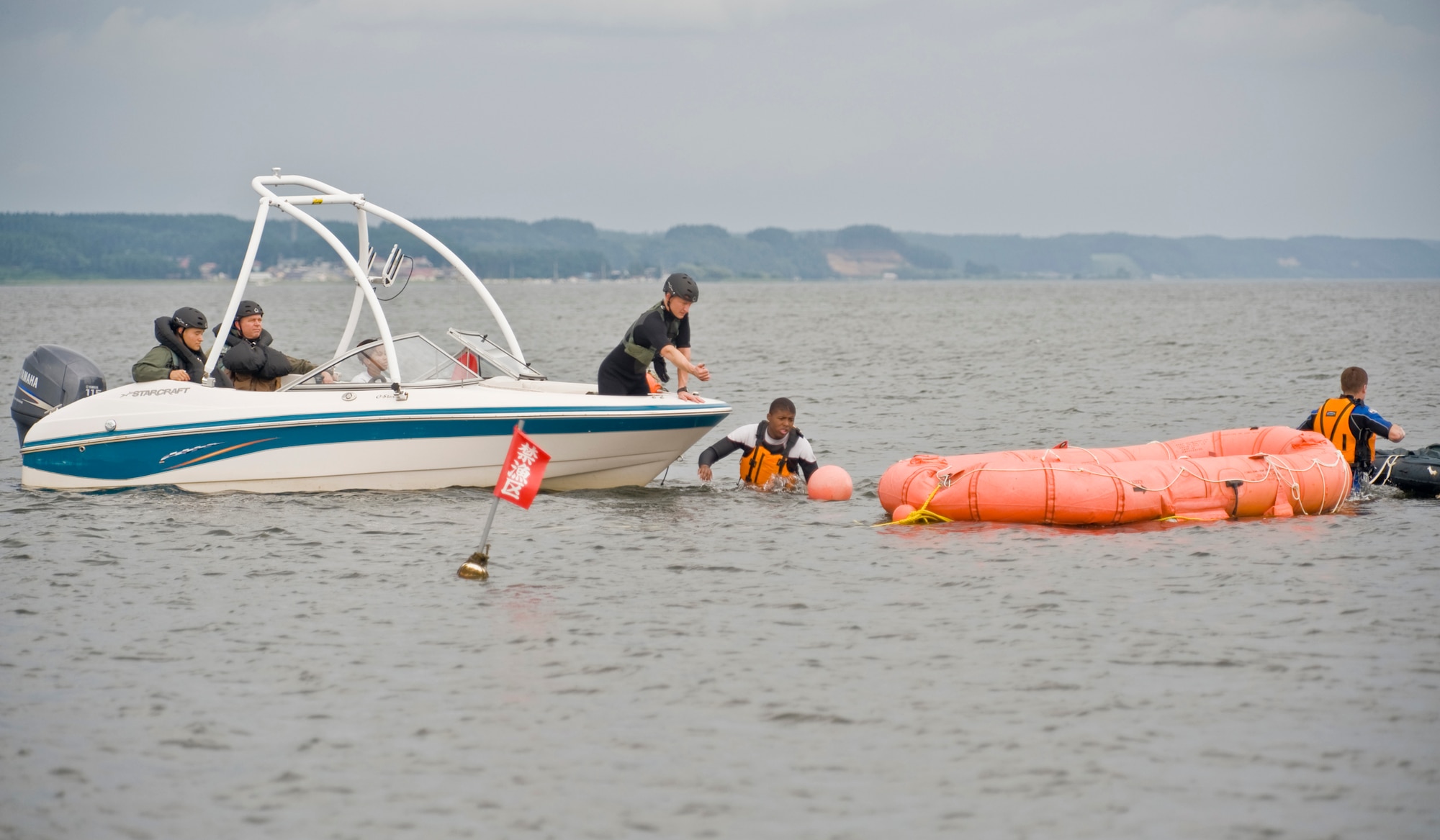 MISAWA AIR BASE, Japan -- An instructor, students and augmentees of a water survival course prepare for training Aug. 12 at Lake Ogawara. Led by the 35th Operations Support Squadron survival, evasion, resistance and escape flight, the training consisted of a block of academics and a block of hands-on demonstrations. (U.S. Air Force photo/Senior Airman Jamal D. Sutter)