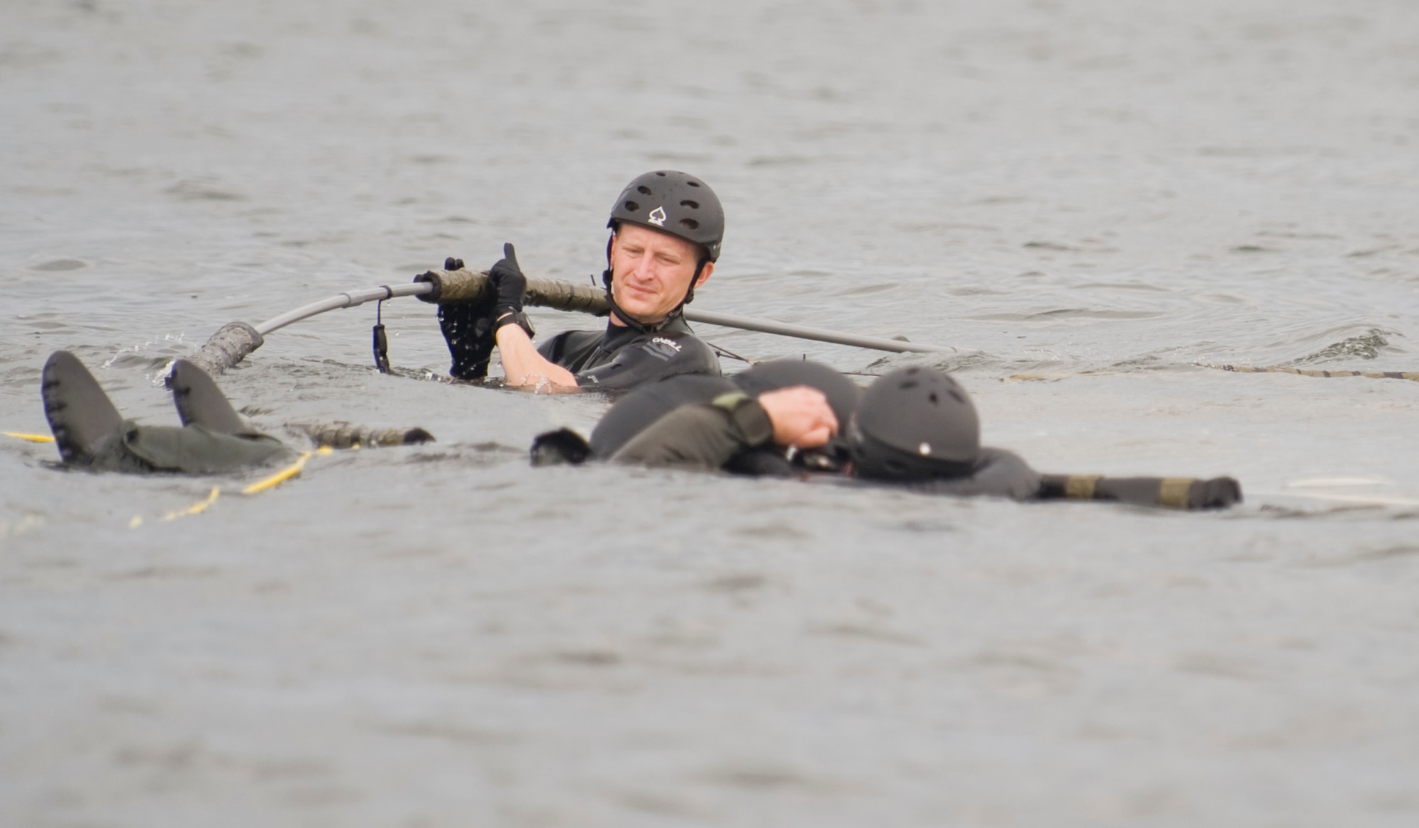 MISAWA AIR BASE, Japan -- Staff Sgt. Benjamin Thomas, 35th Operations Support Squadron survival, evasion, resistance and escape specialist, assists a student during water survival training Aug. 12 at Lake Ogawara. Pilots and other aircrew members take part in the training to stay current with water survival techniques in the event of an emergency. (U.S. Air Force photo/Senior Airman Jamal D. Sutter)