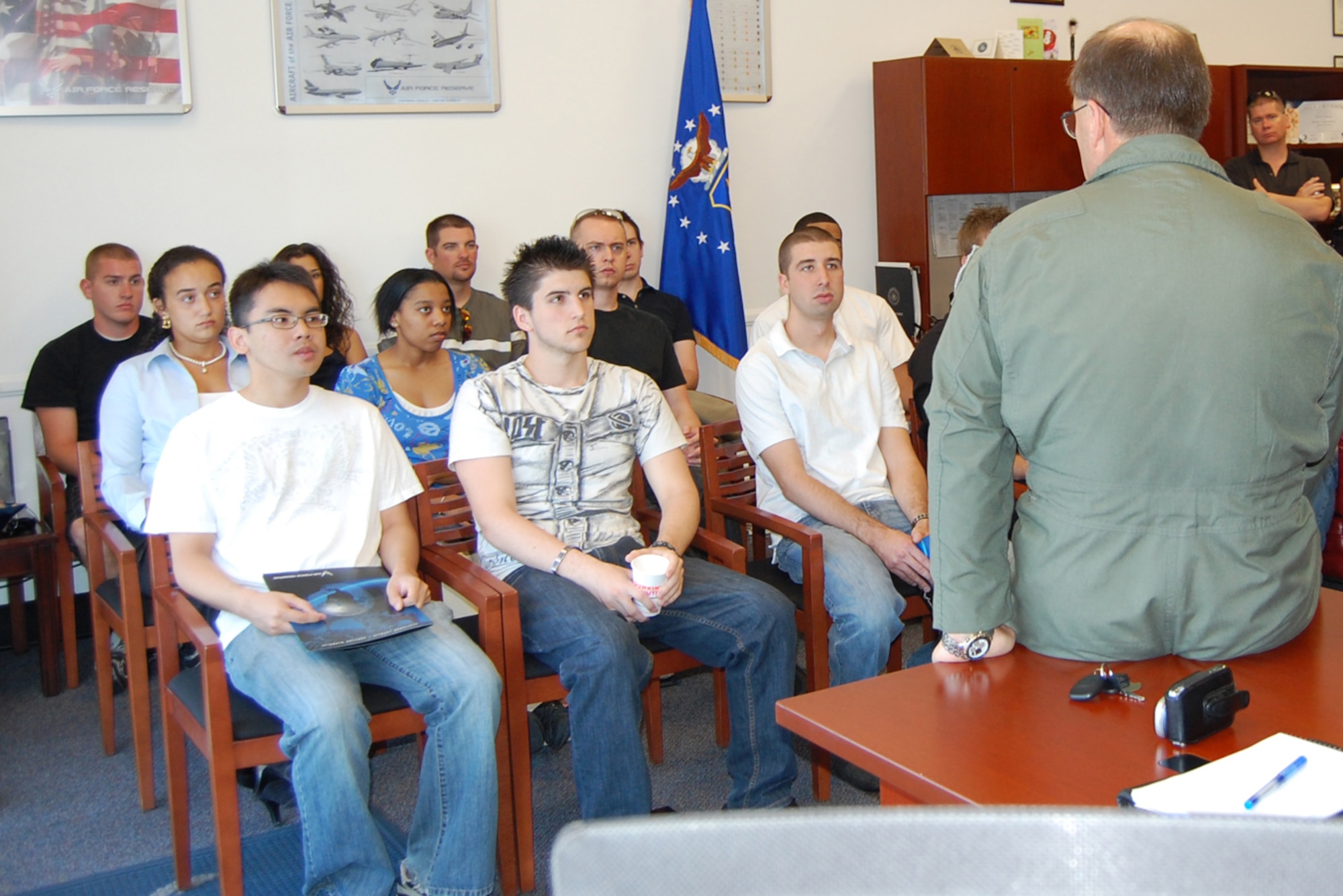 Members of the Delayed Entry Program listen to Col. Brunke (right), 926th Group commander, during a monthly meeting, known as DEP call, Aug. 7 at the Craig Road Air Force Reserve Recruiting station. Colonel Brunke explained how vital their roles are to the group, as well as the Air Force Reserve, and encouraged them to focus on job training, medical readiness and physical fitness.