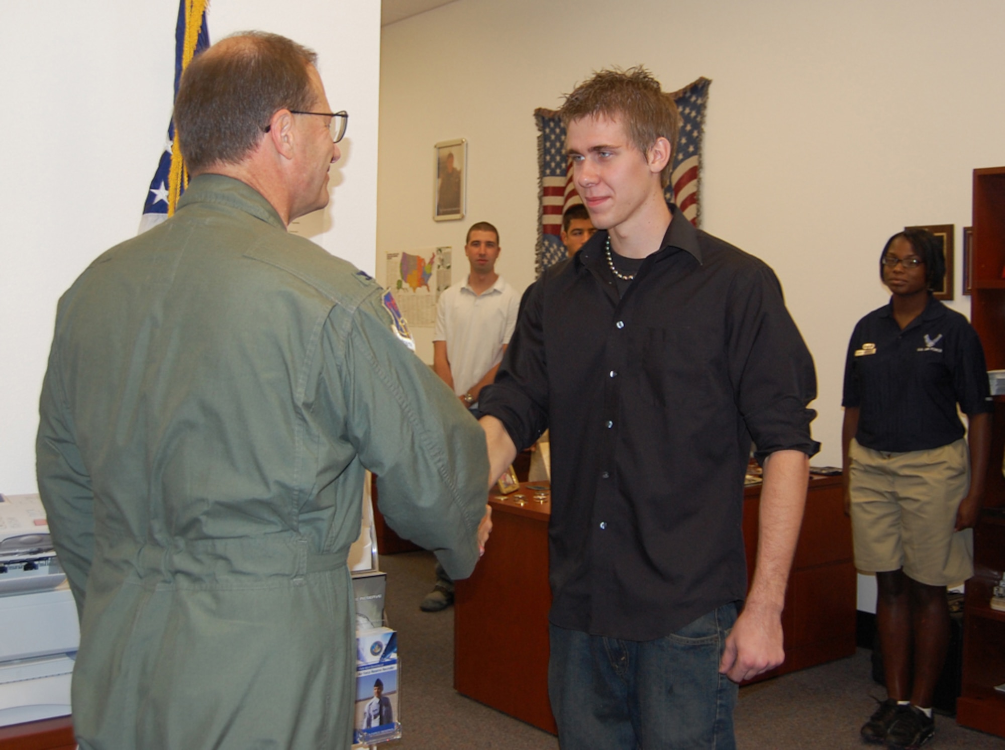 Col. Brunke (left), 926th Group commander, congratulates local Las Vegas resident David Kammler, after administering the Oath of Enlistment during a monthly meeting Aug. 7 at the Craig Road Air Force Reserve Recruiting station. Kammler became part of the Delayed Entry Program, where he enlisted into the Individual Ready Reserve component while awaiting to leave for Basic Military Training. Upon completion of BMT and technical training school, Kammler will serve as an Air Force Reserve vehicle maintenance apprentice with the 555th RED HORSE Squadron here.