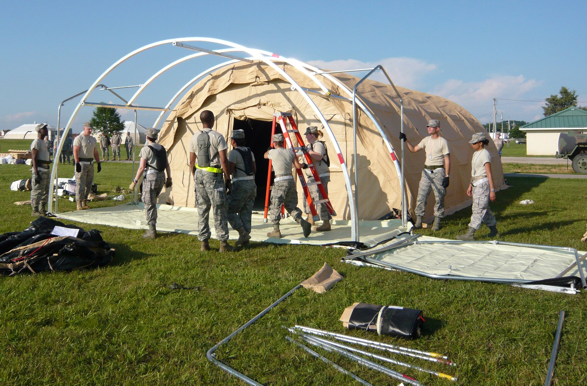 Medical personnel construct Alaskan shelters to set up expeditionary medical support during Operation Vibrant Response, a training exercise held at Camp Atterbury, Indiana, July 12-22. (U.S. Air Force photo by Maj. Sandra Keesee)
