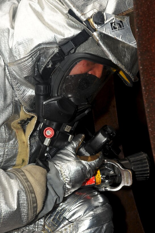 LANGLEY AIR FORCE BASE, Va. -- Staff Sgt. Jesse Zainey, 633d Civil Engineer Squadron firefighter, prepares to enter a crashed C-17 during a Major Accident Response Exercise Aug 12. The MARE scenario involved a C-17 crash with nuclear munitions on board and was designed to test the preparedness of first responders and base personnel. (U.S. Air Force photo/Staff Sgt. Ashley Hawkins)