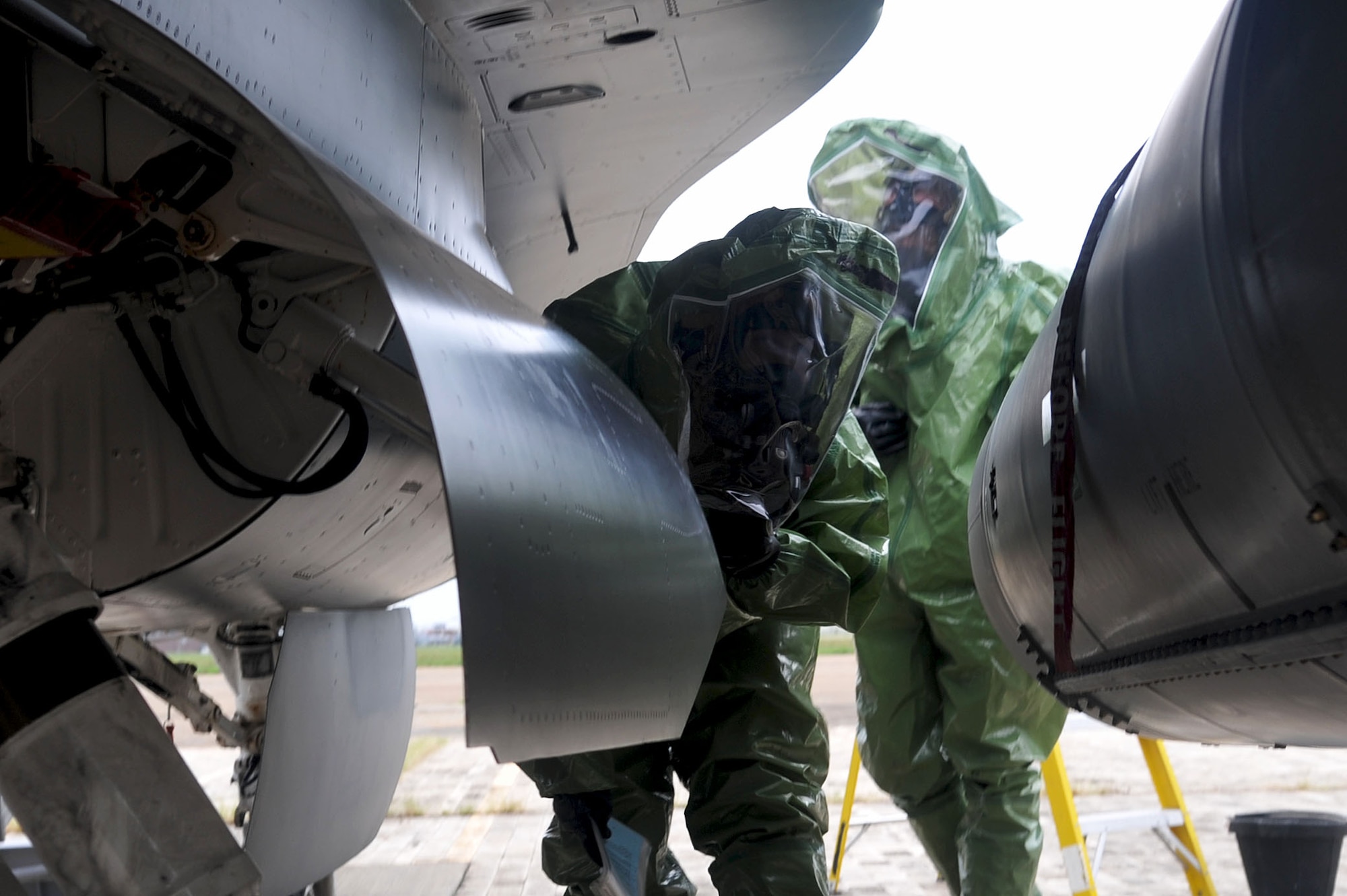 LANGLEY AIR FORCE BASE, Va. -- Airmen from the 1st Component Maintenance Squadron fuels section inspect an F-15 engine for hydrazine leakage during the Major Accident Response Exercise Aug. 12. The MARE tested the preparedness of first responders and base personnel. (U.S. Air Force photo/Staff Sgt. Ashley Hawkins)