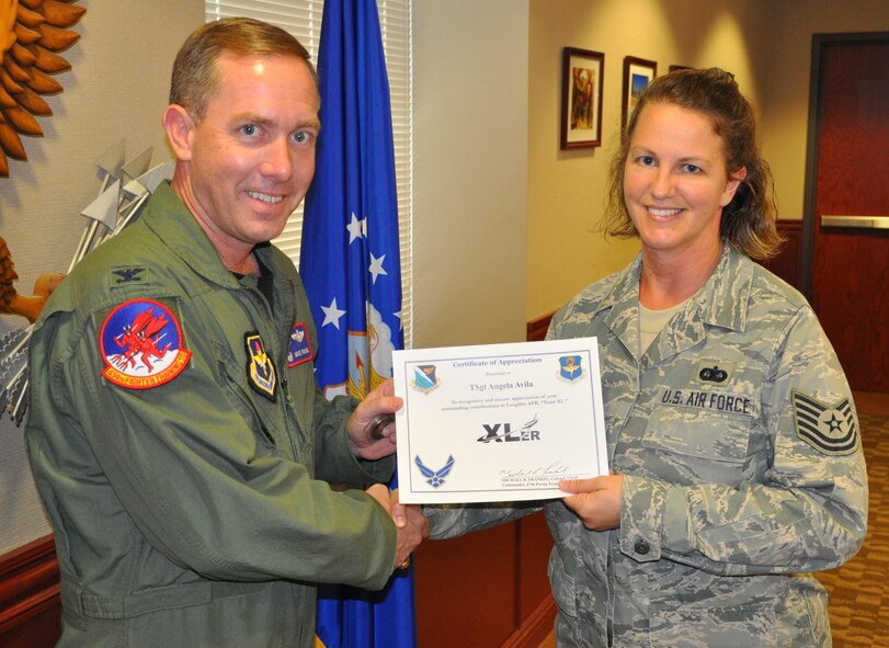 LAUGHLIN AIR FORCE BASE, Texas – Tech. Sgt. Angela Avila, 47th Flying Training Wing, is presented the XLer of the Week award by Col. Michael Frankel, 47th Flying Training Wing commander, August 10. The XLer is a weekly award chosen by 47th FTW leadership and given to individuals who consistently make outstanding contributions to Laughlin and their unit. (U.S. Air Force photo by Airman 1st Class Blake Mize)