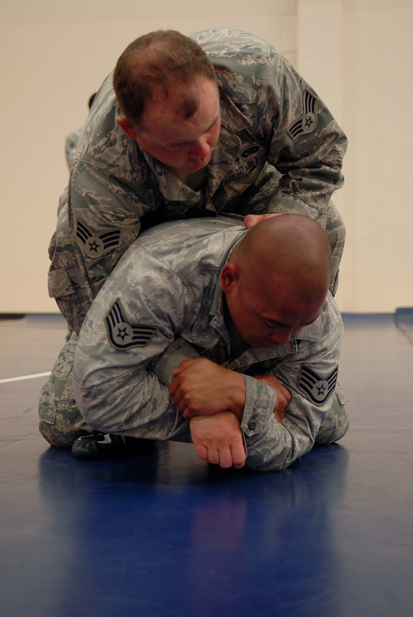VANDENBERG AIR FORCE BASE, Calif. -- Demonstrating an arm bar technique, Staff Sgt. Jonathan Rivera, a 30th Civil Engineer Squadron combatives instructor, incapacitates Senior Airman Justin Egan, a 30th CES combatives instructor, on the mat during a combatives training course at the base fitness center here Tuesday, Aug. 10, 2010.  Airmen from the 30th CES practiced many different techniques to learn how to take control of a fight.  (U.S. Air Force photo/Senior Airman Andrew Satran) 

 

 

 

 

 

 