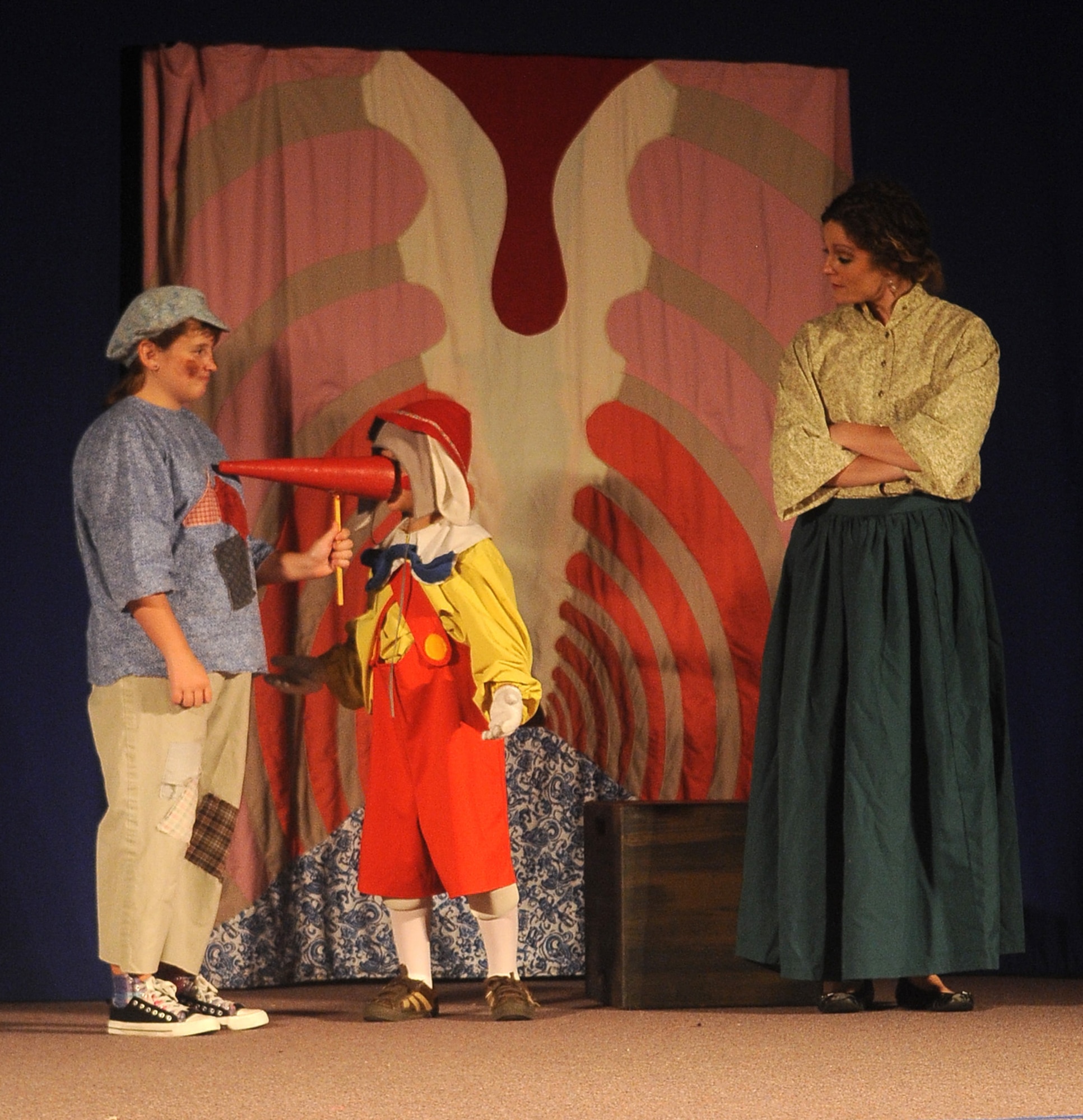 BARKSDALE AIR FORCE BASE, La - (Center) Stephan Danos, Pinocchio, is given a bigger nose after he tells a few lies during the Missoula Theatre production of ?Pinocchio? Aug. 6 at Hoban Hall. The Missoula Children?s Theatre is a company that travels throughout the United States and to 17 other countries, to help children from each community to put on a play in a week?s time. (U.S. Air Force photo/Senior Airman Amber Ashcraft) (RELEASED)