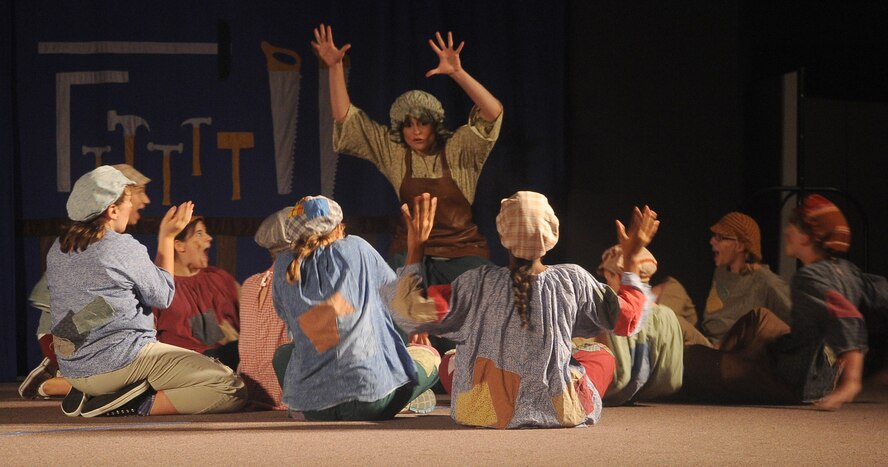 BARKSDALE AIR FORCE BASE, La. - Laura Cole, Missoula Theatre instructor acting as ?Mrs. Geppetto?, begins the story about a wooden puppet who becomes a boy during the Missoula Theatre production of ?Pinocchio? Aug. 6 at Hoban Hall. The Missoula Children?s Theatre is a company that travels throughout the United States and to 17 other countries, to help children from each community to put on a play in a week?s time. (U.S. Air Force photo/Senior Airman Amber Ashcraft) (RELEASED)
