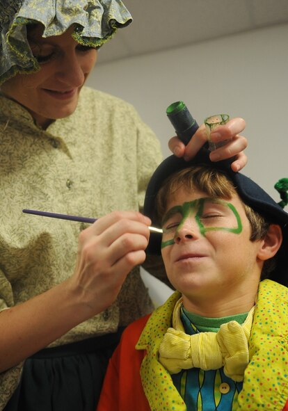 BARKSDALE AIR FORCE BASE, La. - (Left to right) Laura Cole, Missoula Theatre instructor also playing the role as ?Mrs. Geppetto,? puts makeup on Connor Wardell, who acts as Jiminy Cricket, before the Missoula Theatre production of ?Pinocchio? Aug. 6 at Hoban Hall. The Missoula Children?s Theatre is a company that travels throughout the United States and to 17 other countries, to help children from each community to put on a play in a week?s time. (U.S. Air Force photo/Senior Airman Amber Ashcraft) (RELEASED)