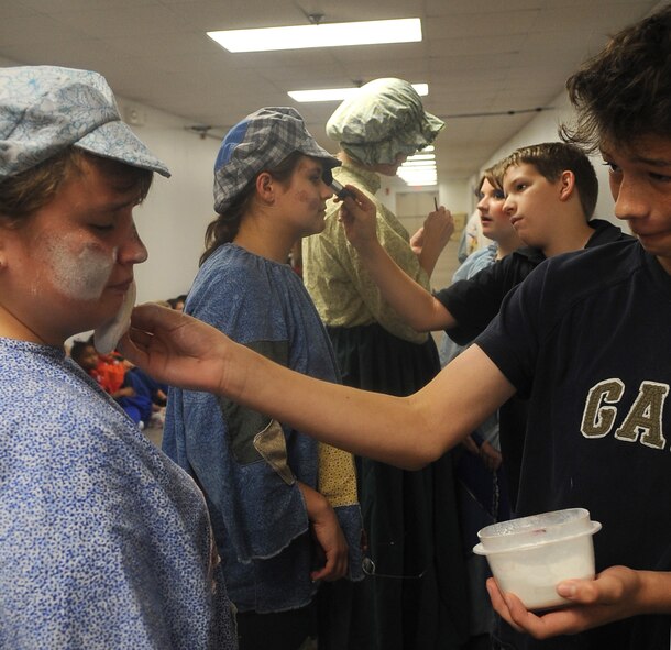 BARKSDALE AIR FORCE BASE, La. - The assistant directors for the Missoula Theatre production of ?Pinocchio? place make up on some of the actors from the play Aug. 6 at Hoban Hall. The Missoula Children?s Theatre is a company that travels throughout the United States and to 17 other countries, to help children from each community to put on a play in a week?s time. (U.S. Air Force photo/Senior Airman Amber Ashcraft) (RELEASED)