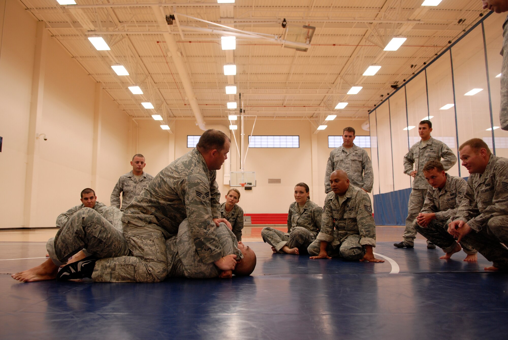 VANDENBERG AIR FORCE BASE, Calif. -- Demonstrating a chokehold,  Senior Airman Justin Egan, a 30th Civil Engineer Squadron combatives instructor, holds Staff Sgt. Jonathan Rivera, a 30th CES combatives instructor, to show the proper technique during a combatives training course at the base fitness center here Tuesday, Aug. 10, 2010.  The instructors focused on combat techniques to train Airmen how to protect themselves in a combat environment.  (U.S. Air Force photo/Senior Airman Andrew Satran) 

 

 

 

 

 