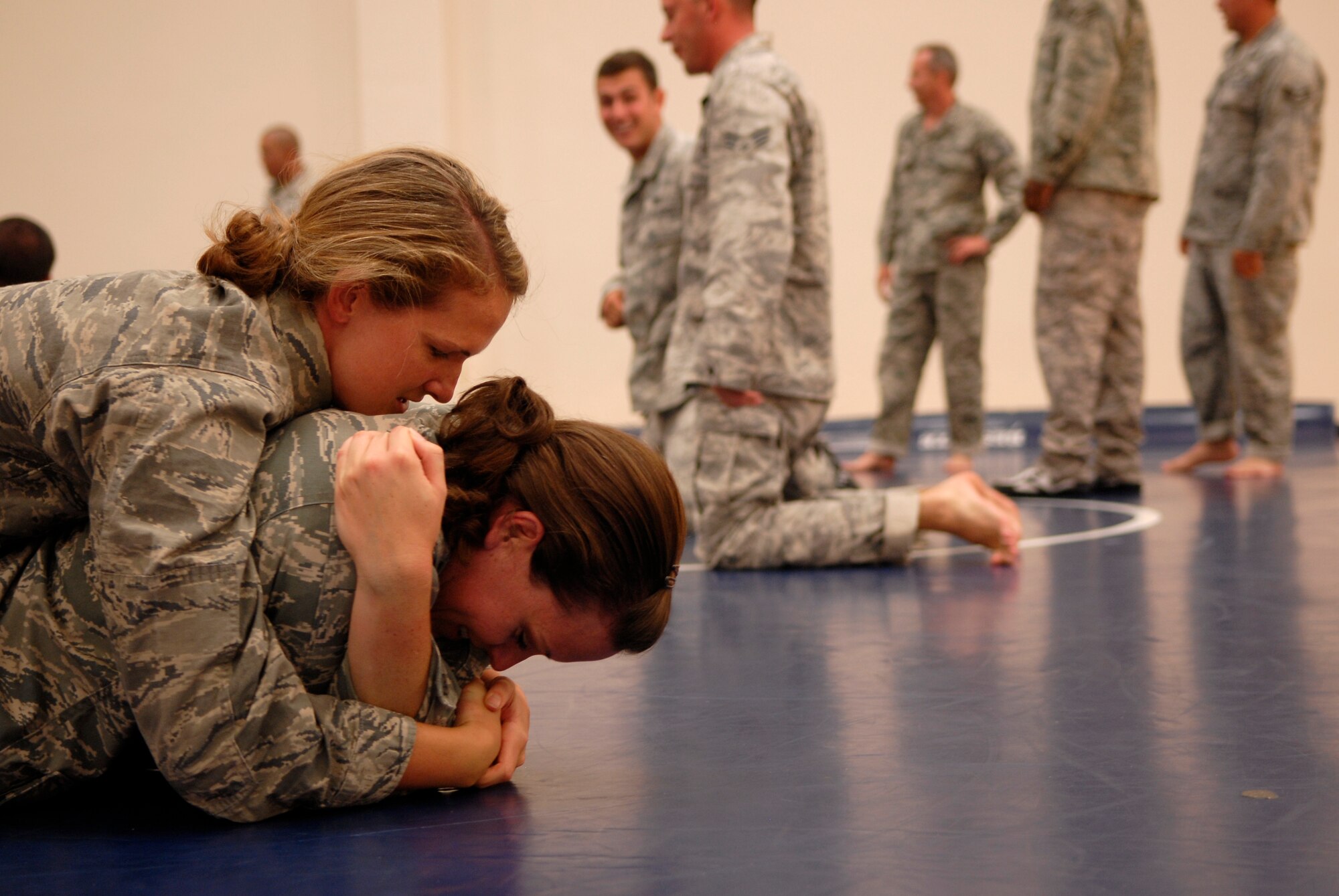 VANDENBERG AIR FORCE BASE, Calif. -- Practicing an escape technique, 1st Lt. Rebecca Bucher, a 30th Civil Engineer Squadron combatives trainee, holds 2nd Lt. Melissa Kromer, a 30th CES combatives trainee, on a mat  during a combatives training course at the base fitness center here Tuesday, Aug. 10, 2010.  The Modern Army Combatives Program helps Airmen maintain readiness for future deployments. (U.S. Air Force photo/Senior Airman Andrew Satran) 

 

 

 

 