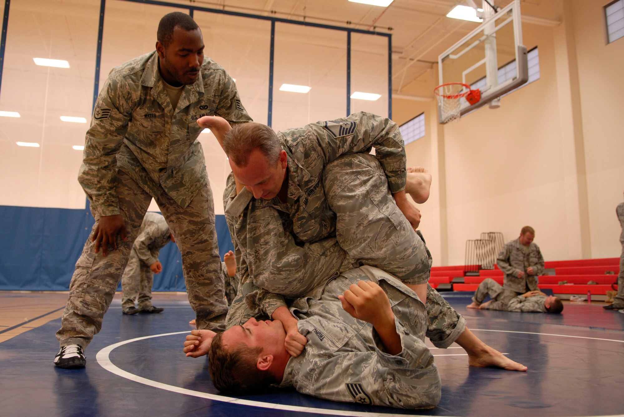 VANDENBERG AIR FORCE BASE, Calif. -- Master Sgt. Daniel Fuller, a 30th Civil Engineer Squadron combatives trainee, chokeholds his opponent, Staff Sgt. Robert Tronu, a 30th CES combatives trainee, during a combatives training course at the base fitness center here Tuesday, Aug. 10, 2010.  Techniques learned during the course are supervised by other instructors to ensure the proper techniques and safety are implemented.  (U.S. Air Force photo/Senior Airman Andrew Satran) 

 

 

 