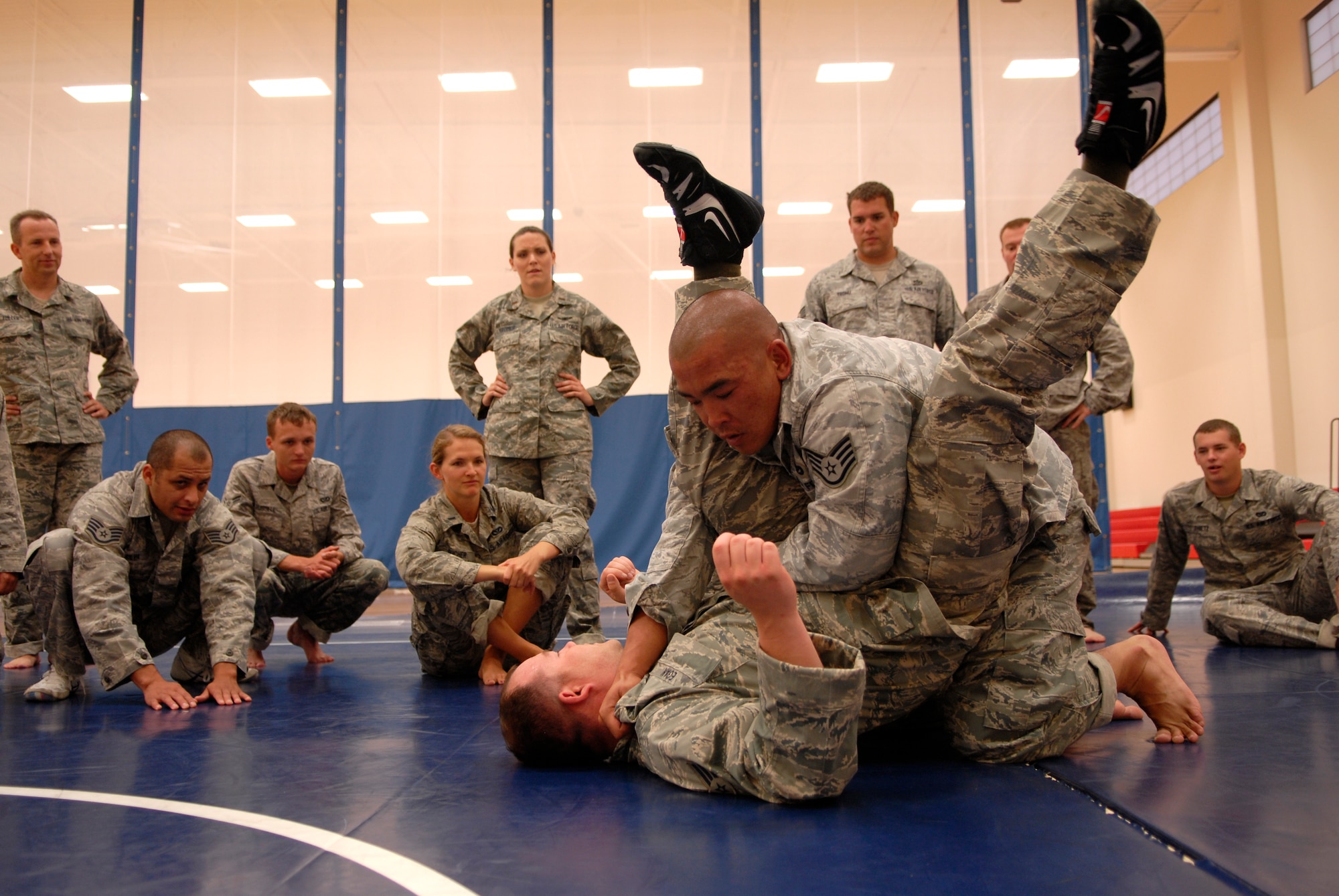 VANDENBERG AIR FORCE BASE, Calif. -- Demonstrating an escape technique, Staff Sgt. Jonathan Rivera, a 30th Civil Engineer Squadron combatives instructor, holds Senior Airman Justin Egan, a 30th CES combatives instructor, on a mat during a combatives training course at the base fitness center here Tuesday, Aug. 10, 2010.  The instructors focused on combat techniques to train Airmen how to protect themselves in a combat environment.  (U.S. Air Force photo/Senior Airman Andrew Satran) 

 

 