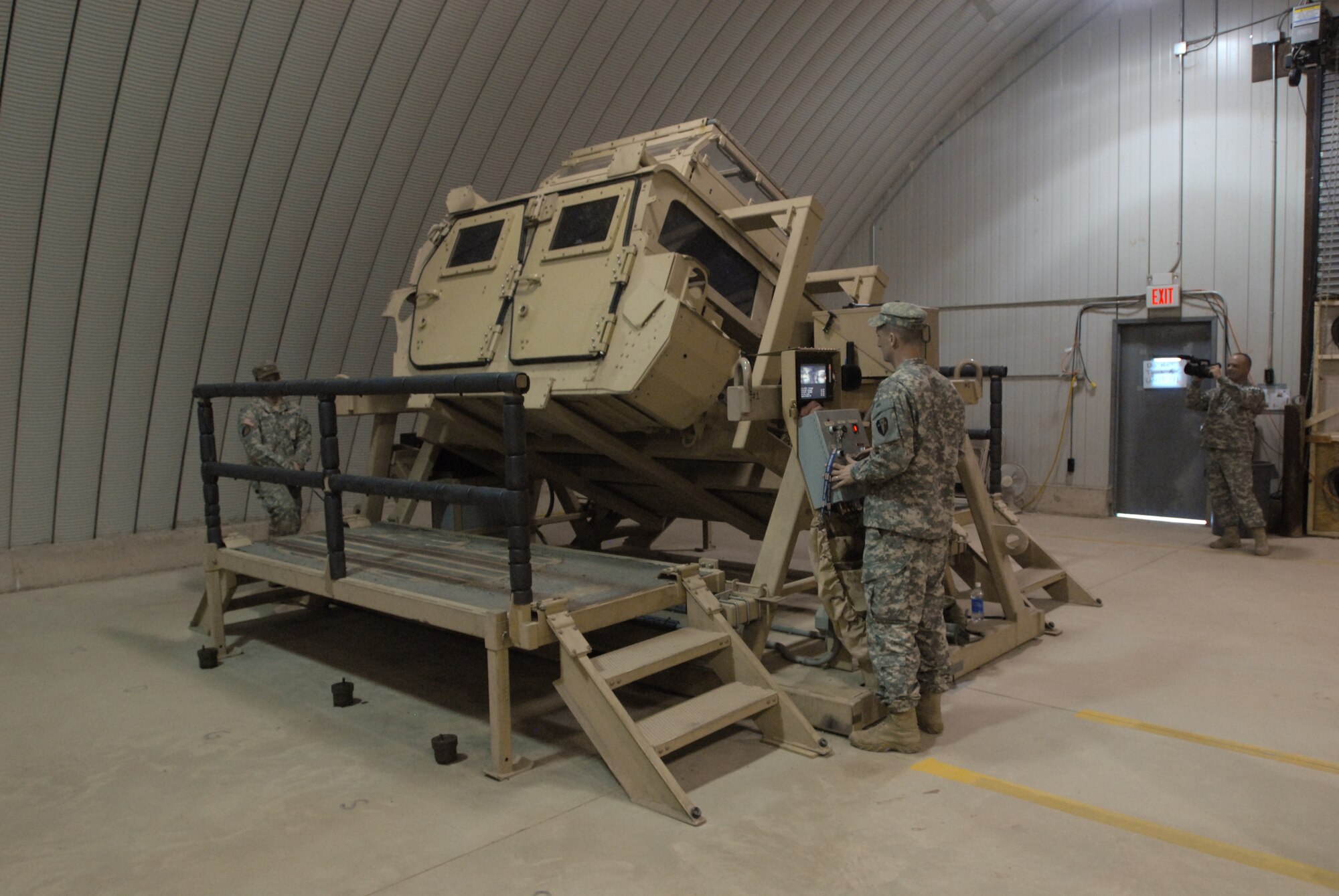 Staff Sgt. Matthew Parsons, an instructor with 72nd Field Artillery Brigade operates the Humvee Egress Assessment Trainer (HEAT) during annual training for Headquarters, Headquarters Company, 99th Regional Support Command at Joint Base McGuire-Dix-Lakehurst on August 5.(U.S. Army photo/ Staff Sgt. Shawn Morris) 