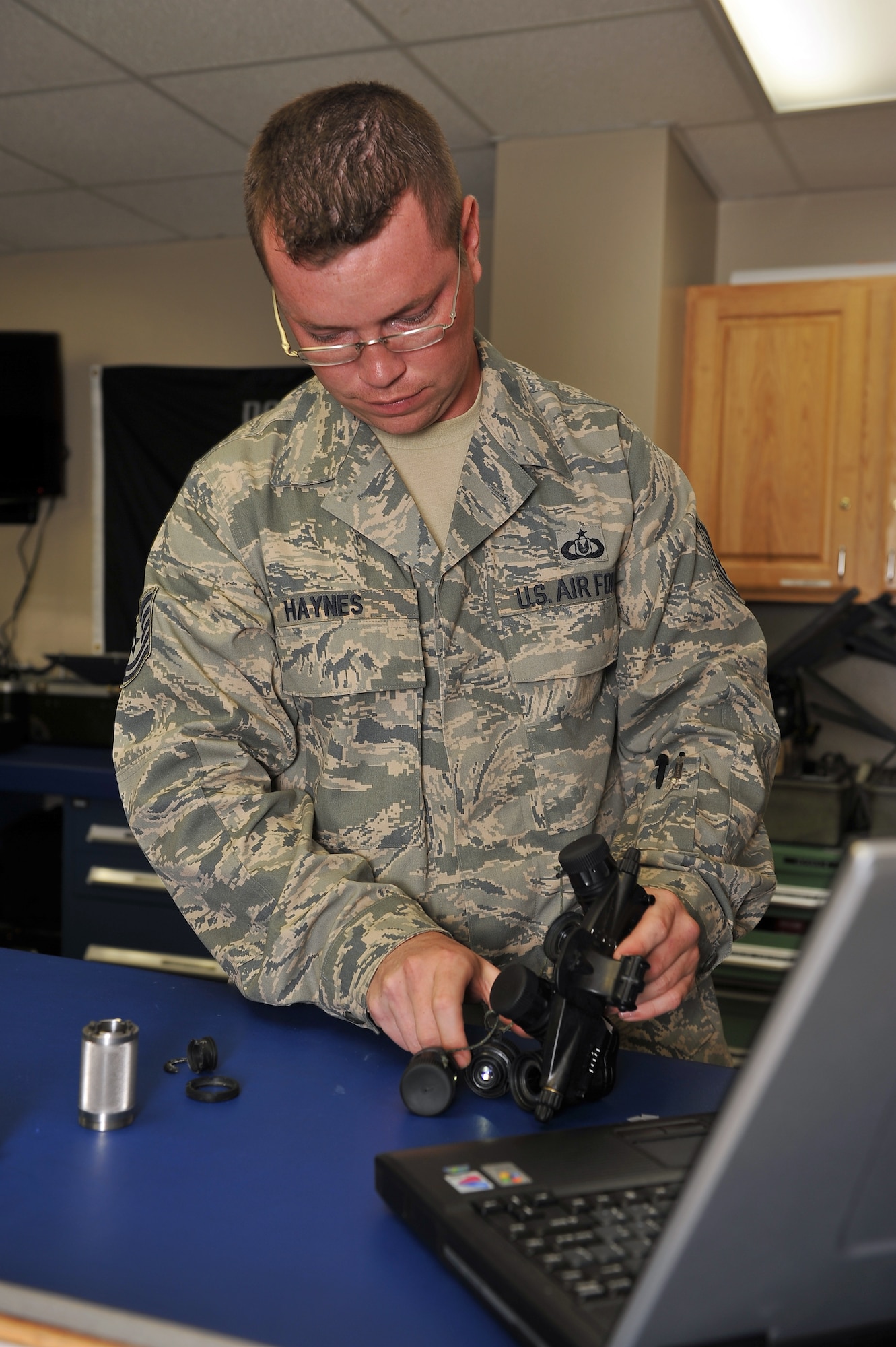 MINOT AIR FORCE BASE, N.D. -- Tech. Sgt. Christopher Haynes, 54th Helicopter Squadron noncommissioned officer-in-charge aircrew flight equipment, performs routine maintenance on a pair of panoramic night vision goggles here Aug. 10. Regular inspection and maintenance of all aircrew equipment is pertinent to keeping all aircrew members prepared for the mission at Minot AFB.  (U.S. Air Force photo by Senior Airman Michael J. Veloz)