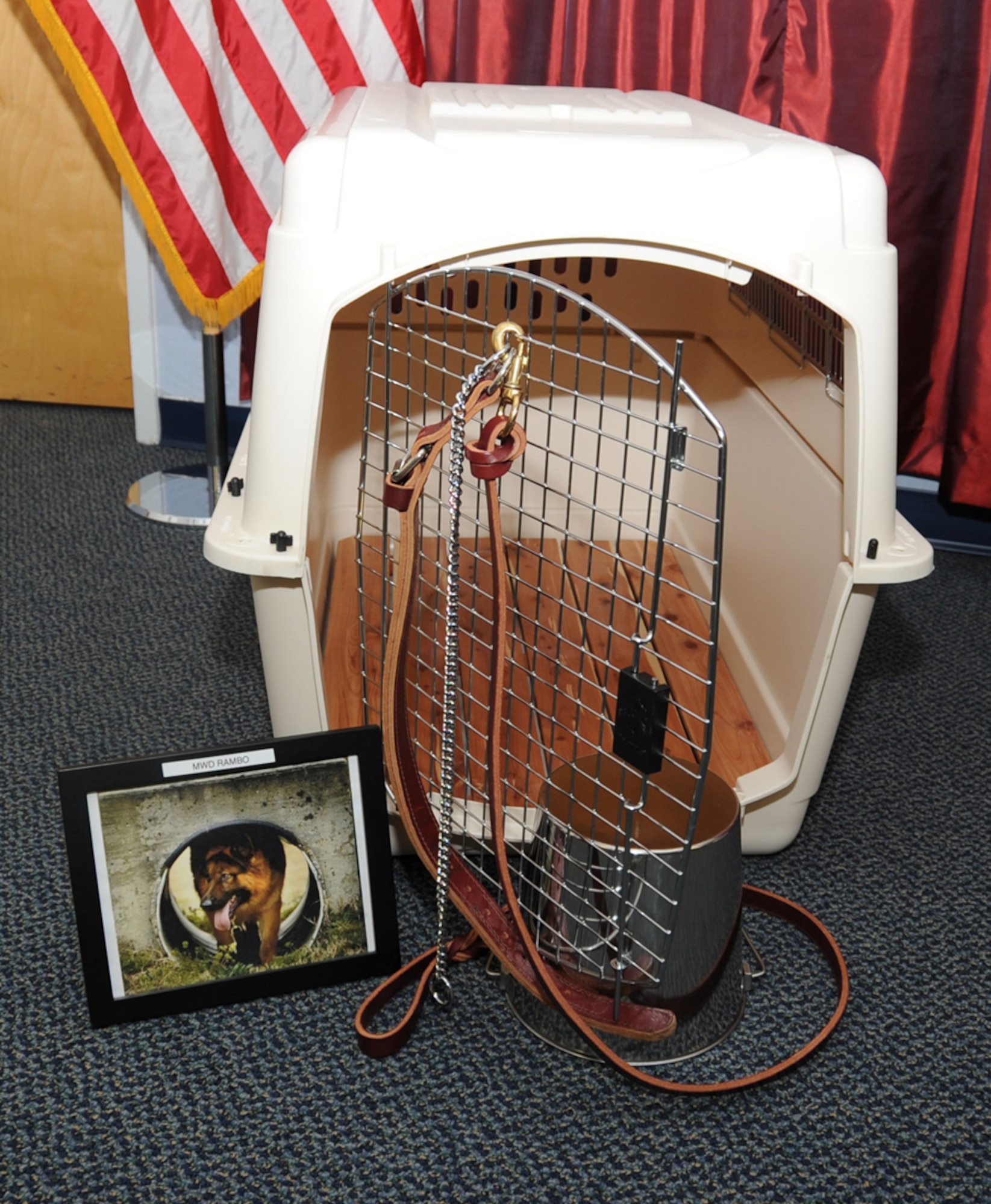 The missing dog display set up by the 87th Security Forces Squadron is the representation of the bond between dog and handler.  The leather leash and chain hanging from the kennel represents the everlasting eternal bond between dog and handler; the empty kennel represents the life that they gave; the inverted bucket serves as reminder that they are no longer here to fulfill their needs of food and water, for which in life they asked for no more in return than companionship and affection. (US Air Force photo/James Hodges)