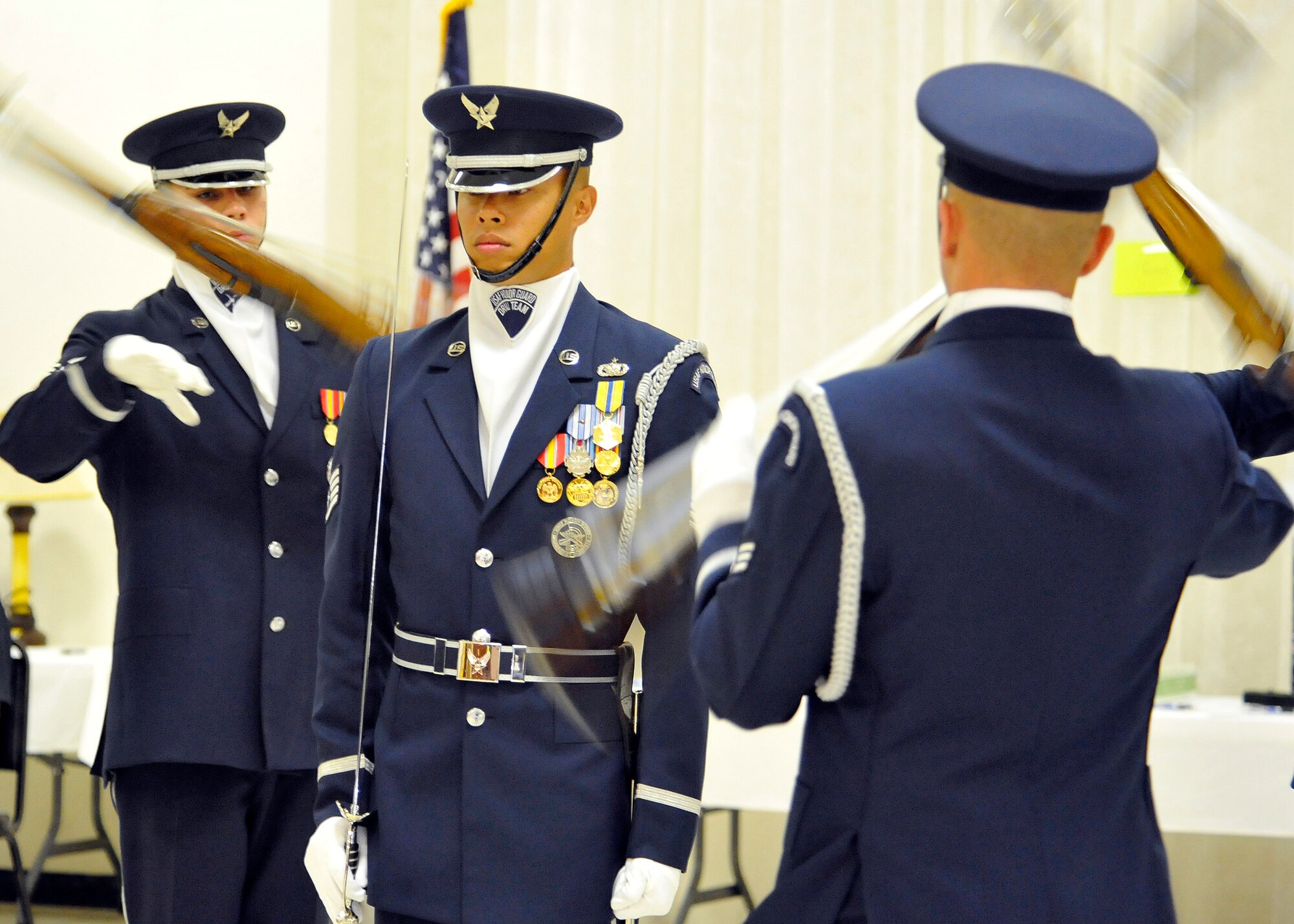 ALAMOGORDO, N.M. -- Senior Airman Jezel Reyes-Torres, Staff Sgt. Jonathan Tomita and Senior Airmen Aaron Fowler, members of the U.S. Air Force Honor Guard Drill Team, perform a four-man team demonstration for the Operation Wounded Warrior Dine and Dance held at the Elks Lodge Aug. 7, 2010. Sixteen members from the AF Honor Guard also performed for the base populous at Holloman Air Force Base a day earlier. The AF Honor Guard Drill Team is the traveling component of the USAF Honor Guard and inspires Air Force awareness among military and civilian audiences through its complex drill routine. (U.S. Air Force photo by Senior Airman Veronica Stamps / Released)